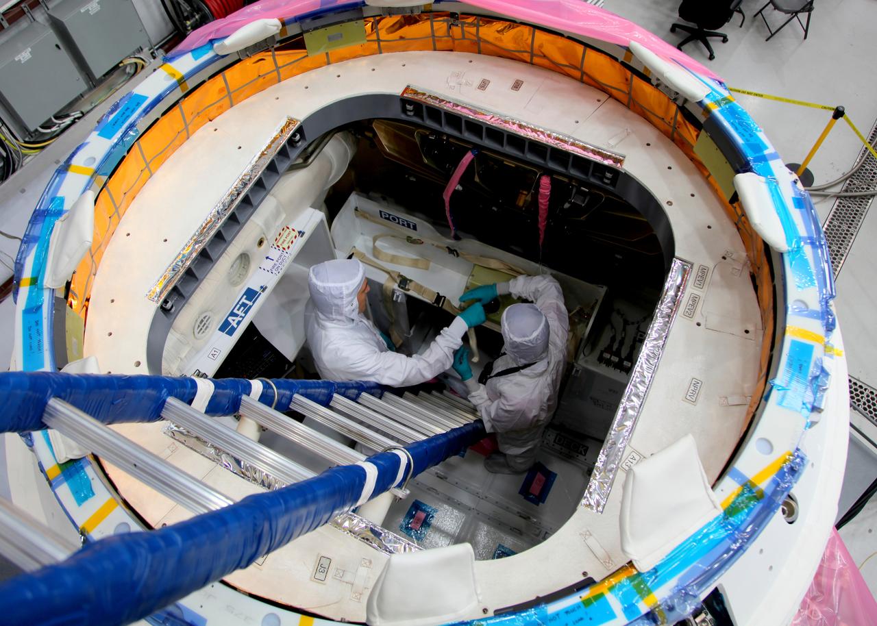 CAPE CANAVERAL, Fla. -- NASA astronaut Megan McArthur, right, takes part in a crew equipment interface test CEIT in order to become familiar with the Space Exploration Technologies Corp. SpaceX Dragon capsule prior to its scheduled April 30 liftoff. The interface test inside a processing hangar at Cape Canaveral Air Force Station's Space Launch Complex-40 was part of prelaunch preparations for the company's next demonstration test flight for NASA's Commercial Orbital Transportation Services COTS program. Under COTS, NASA has partnered with two private companies to launch cargo safely to the International Space Station. Jason Tenenbaum, with SpaceX Mission Operations, left, also takes part in the test. CEIT is an activity that dates back to NASA's Space Shuttle Program, providing astronauts on Earth an opportunity to work with the actual hardware they would use in space. This exercise gave astronauts and engineers the opportunity to assess the compatibility of the equipment and systems aboard Dragon with the procedures to be used by the flight crew and flight controllers once the capsule is berthed at the space station. For more information, visit www.nasa.gov/exploration/commercial/cargo/spacex_index.html. Image courtesy: SpaceX/Paul Bonness      