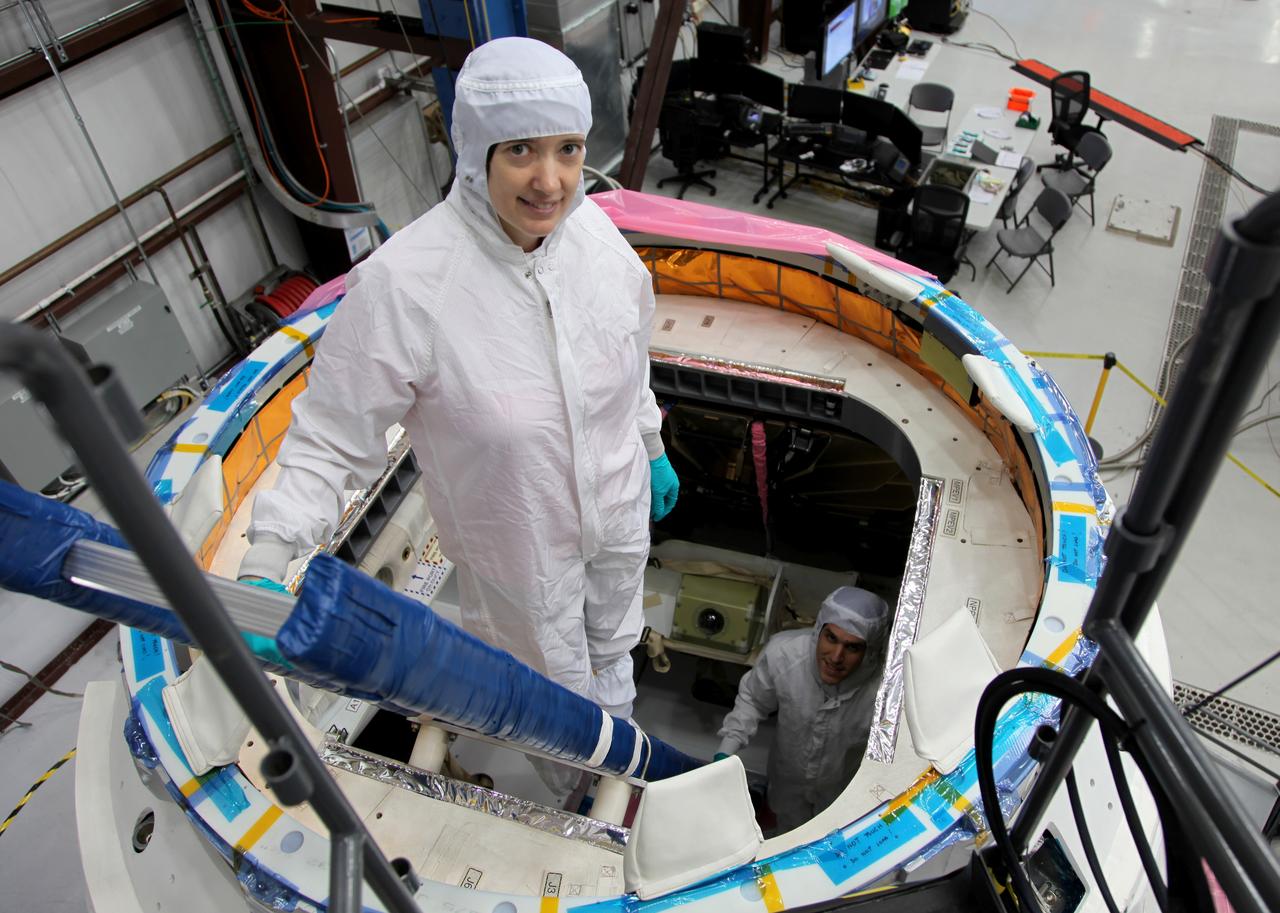 CAPE CANAVERAL, Fla. -- NASA astronaut Megan McArthur, foreground, takes part in a crew equipment interface test CEIT in order to become familiar with the Space Exploration Technologies Corp. SpaceX Dragon capsule prior to its scheduled April 30 liftoff. The interface test inside a processing hangar at Cape Canaveral Air Force Station's Space Launch Complex-40 was part of prelaunch preparations for the company's next demonstration test flight for NASA's Commercial Orbital Transportation Services COTS program. Under COTS, NASA has partnered with two private companies to launch cargo safely to the International Space Station. Jason Tenenbaum, with SpaceX Mission Operations, background, also takes part in the test. CEIT is an activity that dates back to NASA's Space Shuttle Program, providing astronauts on Earth an opportunity to work with the actual hardware they would use in space. This exercise gave astronauts and engineers the opportunity to assess the compatibility of the equipment and systems aboard Dragon with the procedures to be used by the flight crew and flight controllers once the capsule is berthed at the space station. For more information, visit www.nasa.gov/exploration/commercial/cargo/spacex_index.html. Image courtesy: SpaceX/Paul Bonness 