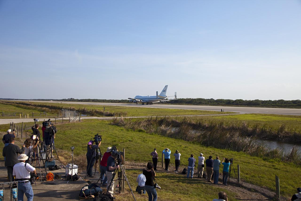 CAPE CANAVERAL, Fla. – Media representatives are on hand at the Shuttle Landing Facility at NASA’s Kennedy Space Center in Florida for the arrival of the Shuttle Carrier Aircraft.  The aircraft, known as an SCA, arrived at 5:35 p.m. EDT to prepare for shuttle Discovery’s ferry flight to the Washington Dulles International Airport in Sterling, Va., on April 17. This SCA, designated NASA 905, is a modified Boeing 747 jet airliner, originally manufactured for commercial use. One of two SCAs employed over the course of the Space Shuttle Program, NASA 905 is assigned to the remaining ferry missions, delivering the shuttles to their permanent public display sites.  NASA 911 was decommissioned at the NASA Dryden Flight Research Center in California in February. Discovery will be placed on permanent public display in the Smithsonian's National Air and Space Museum Steven F. Udvar-Hazy Center in Chantilly, Va.  For more information on the SCA, visit http:__www.nasa.gov_centers_dryden_news_FactSheets_FS-013-DFRC.html. For more information on shuttle transition and retirement activities, visit http:__www.nasa.gov_shuttle. Photo credit: NASA_Frankie Martin