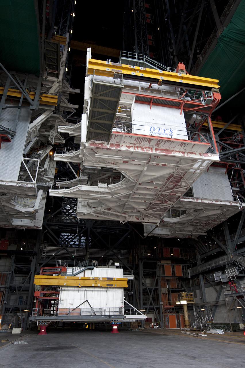 CAPE CANAVERAL, Fla. – At NASA’s Kennedy Space Center in Florida, a crane lowers a space shuttle-era work platform from high bay 3 inside the Vehicle Assembly Building, or VAB. The platform has been moved to the VAB north parking area for temporary storage. The work is part of a center-wide refurbishment initiative under the Ground Systems Development and Operations, or GSDO, Program. High bay 3 is being refurbished to accommodate NASA’s Space Launch System and a variety of other spacecraft. Photo credit: NASA_Kim Shiflett