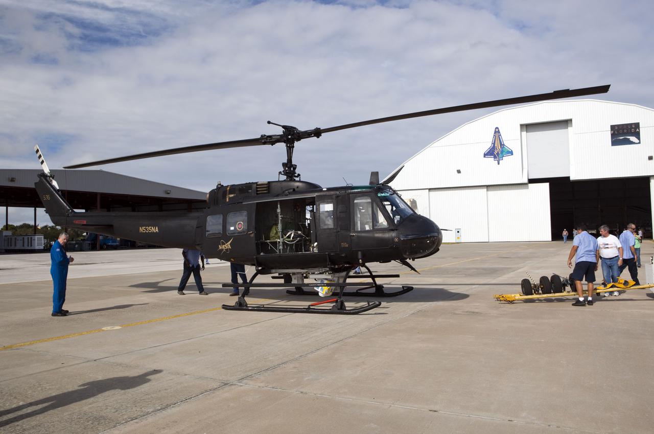 CAPE CANAVERAL, Fla. – Near the Shuttle Landing Facility at NASA's Kennedy Space Center in Florida, a space agency team installed and tested hazard avoidance instrumentation on a Huey helicopter. Led by the Johnson Space Center and supported by Jet Propulsion Laboratory and Langley Research Center, the Autonomous Landing Hazard Avoidance Technology, or ALHAT, laser system provides a planetary lander the ability to precisely land safely on a surface while detecting any dangerous obstacles such as rocks, holes and slopes. Just north of Kennedy's Shuttle Landing Facility runway, a rock- and crater-filled planetary scape has been built so engineers can test the ability to negotiate away from risks. Photo credit: NASA_Dmitri Gerondidakis