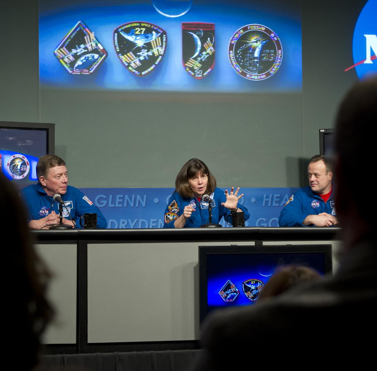 Astronaut Catherine Coleman, center, Expedition 26 and 27 flight engineer, discusses her mission to the International Space Station during a visit to NASA Headquarters in Washington, Tuesday, Feb. 14, 2012.  Coleman is seen with fellow astronauts Mike Fossum, left, and Ron Garan.  Fossum was a flight engineer on Expedition 28 and Commander of Expedition 29.  Garan was a flight engineer on Expeditions 27 & 28.  Photo Credit:  (NASA/Carla Cioffi)