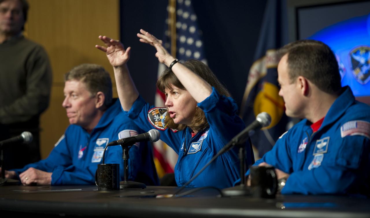 Astronaut Catherine Coleman, center, Expedition 26 and 27 flight engineer, discusses her mission to the International Space Station during a visit to NASA Headquarters in Washington, Tuesday, Feb. 14, 2012.  Coleman is seen with fellow astronauts Mike Fossum, left, and Ron Garan.  Fossum was a flight engineer on Expedition 28 and Commander of Expedition 29.  Garan was a flight engineer on Expeditions 27 & 28.  Photo Credit:  (NASA/Carla Cioffi)
