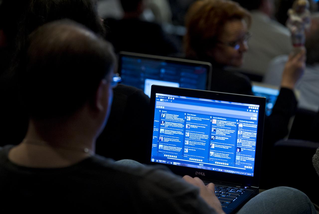 A NASA Twitter follower tweets during astronaut Ron Garan's Tweetup at NASA Headquarters in Washington, Tuesday, Feb. 14, 2012.   Garan was a flight engineer on both the Expedition 27 and 28 missions at the International Space Station.  Photo Credit:  (NASA/Carla Cioffi)
