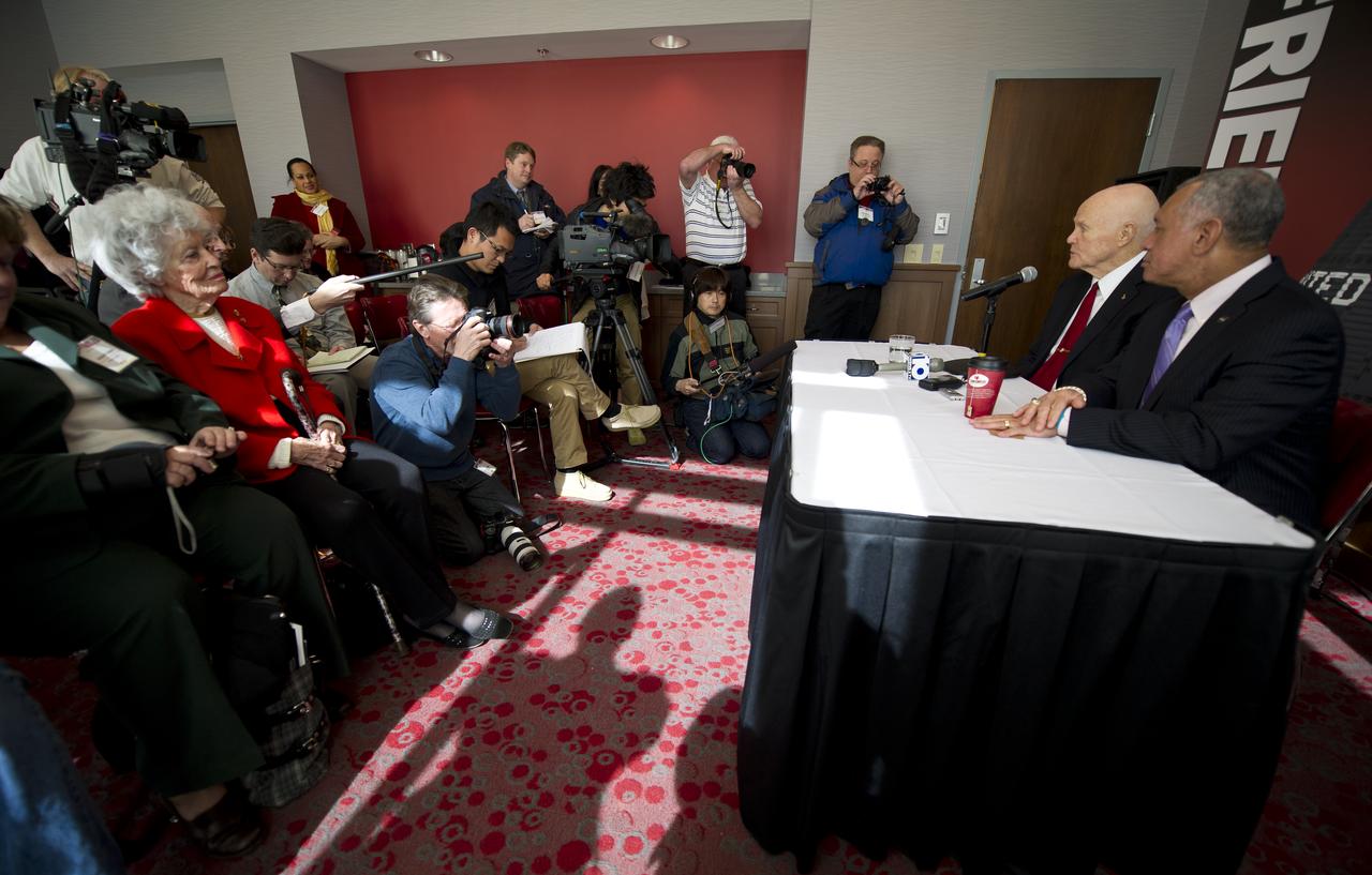 NASA Administrator Charles Bolden, seated right, and Sen. John Glenn address questions from the press during a briefing at Ohio State University as John Glenn's wife Annie Glenn, seated in red, looks on Monday, Feb. 20, 2012, in Columbus, Ohio.  Today marks the 50th anniversary of Glenn's historic flight. Glenn was the first American to orbit Earth.  Photo Credit: (NASA/Bill Ingalls)