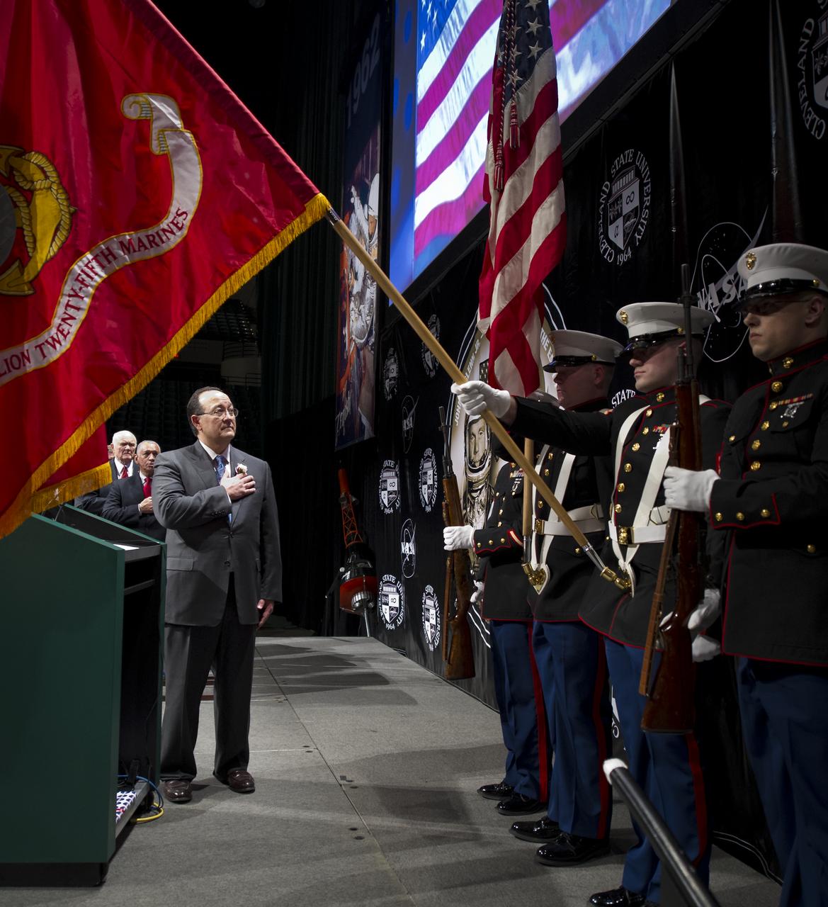 NASA Glenn Research Center Director Ray Lugo, foreground, NASA Administrator Charles Bolden, and Sen. John Glenn, background, stand during the presentation of colors by the 3rd Battalion, 25th Marine Regiment, at the start of an event celebrating John Glenn's legacy and 50 years of americans in orbit held at the Cleveland State University Wolstein Center on Friday, March 3, 2012 in Cleveland, Ohio.  Photo Credit: (NASA/Bill Ingalls)
