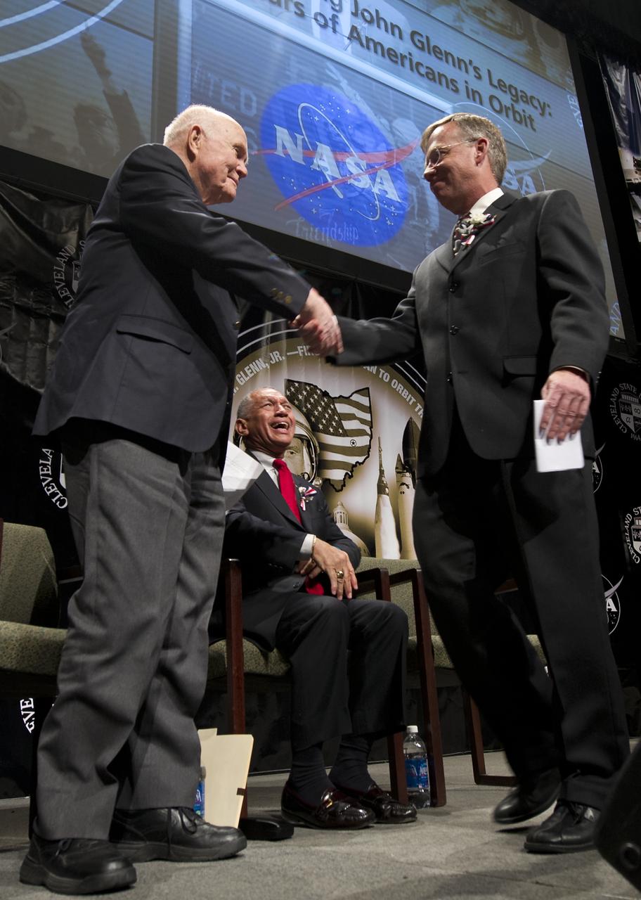 Sen. John Glenn, left, shakes hands with former Astronaut Steve Lindsey as NASA Administrator Charles Bolden smiles at an event celebrating John Glenn's legacy and 50 years of americans in orbit held at the Cleveland State University Wolstein Center on Friday, March 3, 2012 in Cleveland, Ohio.  In 1998 Lindsey flew onboard the space shuttle Discovery along with then 77 year-old Sen. John Glenn for the STS-95 mission.  Glenn became the first American to orbit Earth in 1962.  Photo Credit: (NASA/Bill Ingalls)