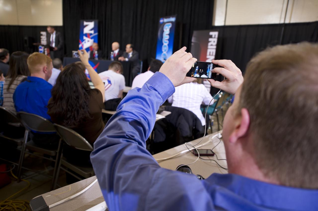 A NASA Tweetup attendee frames a picture of Sen. John Glenn at an event celebrating John Glenn's legacy and 50 years of americans in orbit held at the Cleveland State University Wolstein Center on Friday, March 3, 2012 in Cleveland, Ohio. Glenn became the first American to orbit Earth in 1962.  Photo Credit: (NASA/Bill Ingalls)