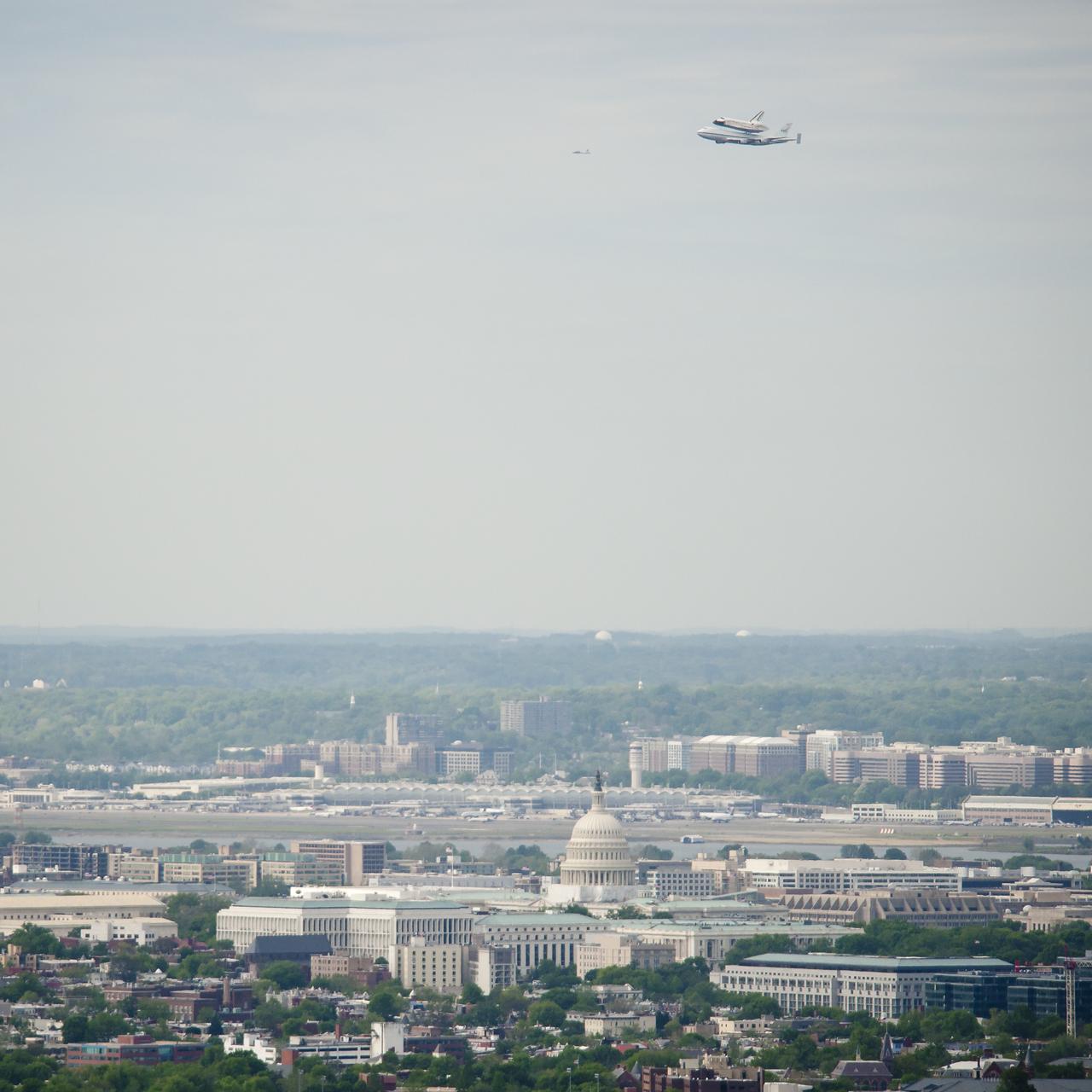 Space shuttle Discovery, mounted atop a NASA 747 Shuttle Carrier Aircraft (SCA) flies near the U.S. Capitol, Tuesday, April 17, 2012, in Washington. Discovery, the first orbiter retired from NASA’s shuttle fleet, completed 39 missions, spent 365 days in space, orbited the Earth 5,830 times, and traveled 148,221,675 miles. NASA will transfer Discovery to the National Air and Space Museum to begin its new mission to commemorate past achievements in space and to educate and inspire future generations of explorers. Photo Credit: (NASA/Bill Ingalls)