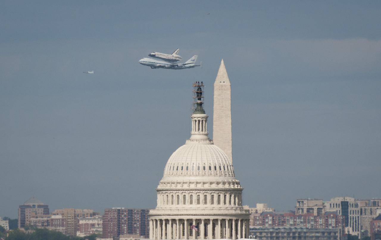 Space shuttle Discovery, mounted atop a NASA 747 Shuttle Carrier Aircraft (SCA) flies near the U.S. Capitol, Tuesday, April 17, 2012, in Washington. Discovery, the first orbiter retired from NASA’s shuttle fleet, completed 39 missions, spent 365 days in space, orbited the Earth 5,830 times, and traveled 148,221,675 miles. NASA will transfer Discovery to the National Air and Space Museum to begin its new mission to commemorate past achievements in space and to educate and inspire future generations of explorers. Photo Credit: (NASA/Rebecca Roth)