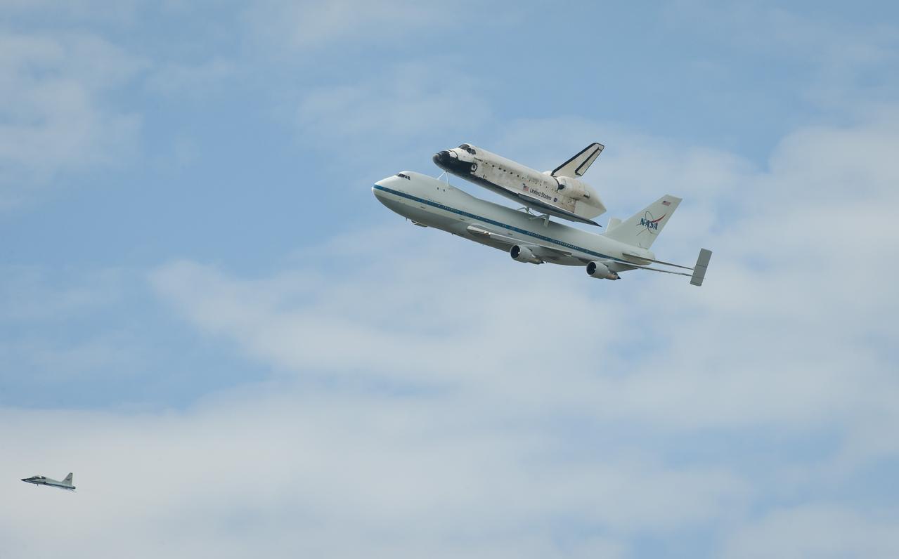 Space shuttle Discovery, mounted atop a NASA 747 Shuttle Carrier Aircraft (SCA) flies near the U.S. Capitol, Tuesday, April 17, 2012, in Washington. Discovery, the first orbiter retired from NASA’s shuttle fleet, completed 39 missions, spent 365 days in space, orbited the Earth 5,830 times, and traveled 148,221,675 miles. NASA will transfer Discovery to the National Air and Space Museum to begin its new mission to commemorate past achievements in space and to educate and inspire future generations of explorers. Photo Credit: (NASA/Rebecca Roth)