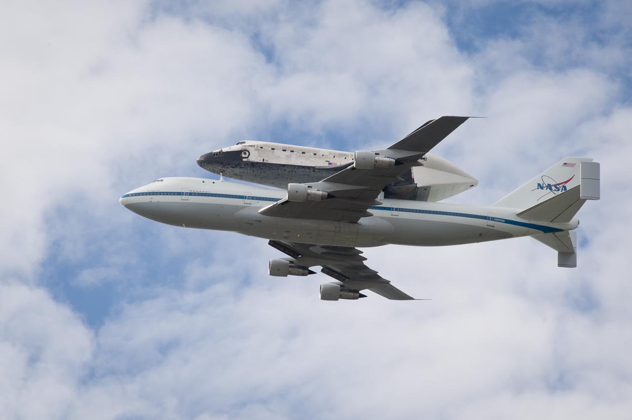 Space shuttle Discovery, mounted atop a NASA 747 Shuttle Carrier Aircraft (SCA) flies near the U.S. Capitol, Tuesday, April 17, 2012, in Washington. Discovery, the first orbiter retired from NASA’s shuttle fleet, completed 39 missions, spent 365 days in space, orbited the Earth 5,830 times, and traveled 148,221,675 miles. NASA will transfer Discovery to the National Air and Space Museum to begin its new mission to commemorate past achievements in space and to educate and inspire future generations of explorers. Photo Credit: (NASA/Michael Porterfield)