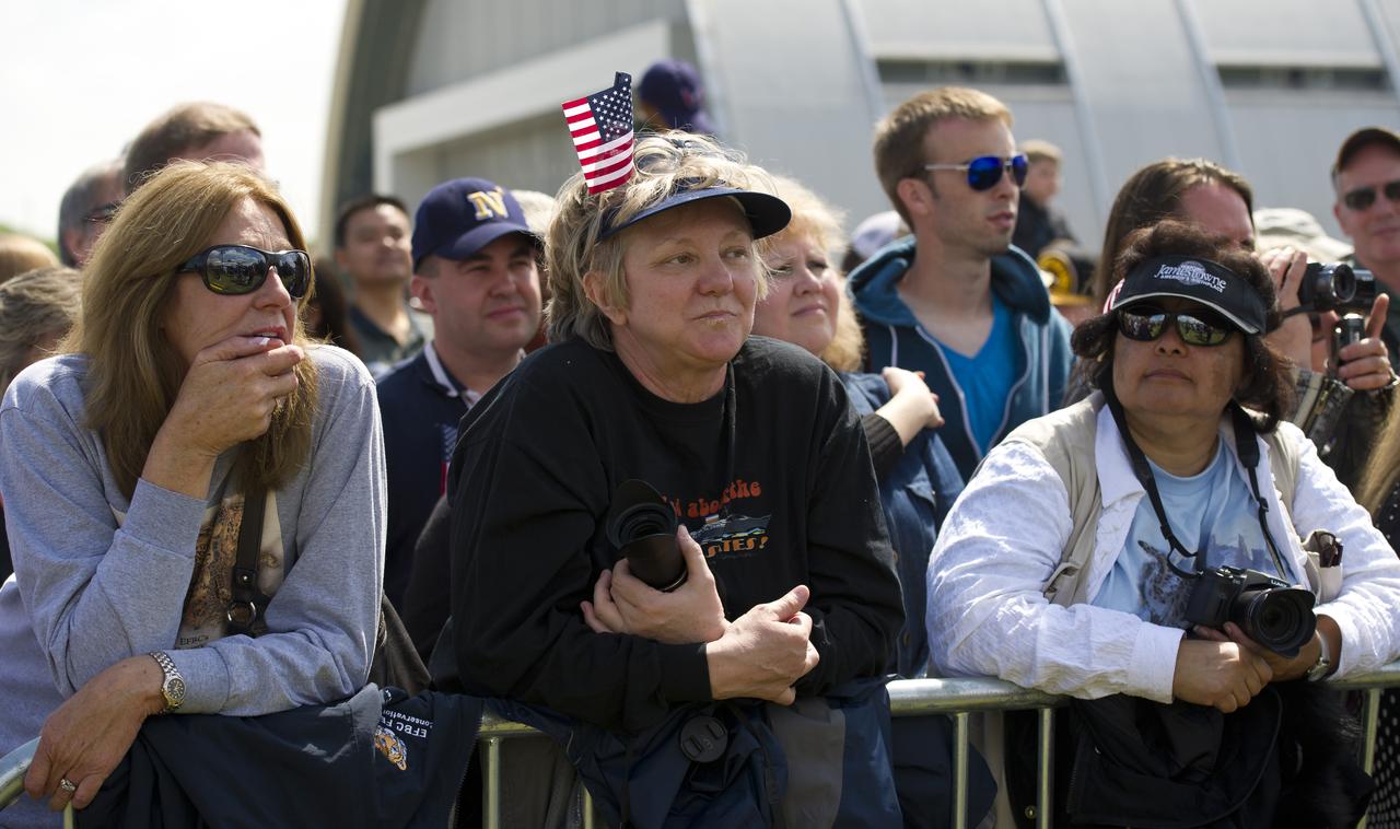 Bettye Kozlowski, center, and Francesca Wright, right, from Santa Clarita, CA attend the transfer ceremony for space shuttle Discovery, Thursday, April 19, 2012, at the Smithsonian's Steven F. Udvar-Hazy Center in Chantilly, Va.  Discovery, the first orbiter retired from NASA’s shuttle fleet, which completed 39 missions, spent 365 days in space, orbited the Earth 5,830 times, and traveled 148,221,675 miles will take the place of Enterprise at the center to commemorate past achievements in space and to educate and inspire future generations of explorers at the center. Photo Credit: (NASA/Carla Cioffi)