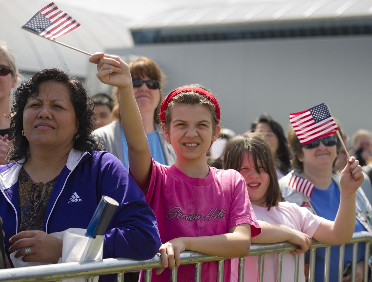 Rachel Ledford, in prink shirt, and Noelle Leford, right, from Butler, PA attend the transfer ceremony for space shuttle Discovery, Thursday, April 19, 2012, at the Smithsonian's Steven F. Udvar-Hazy Center in Chantilly, Va.  Discovery, the first orbiter retired from NASA’s shuttle fleet, which completed 39 missions, spent 365 days in space, orbited the Earth 5,830 times, and traveled 148,221,675 miles will take the place of Enterprise at the center to commemorate past achievements in space and to educate and inspire future generations of explorers at the center. Photo Credit: (NASA/Carla Cioffi)