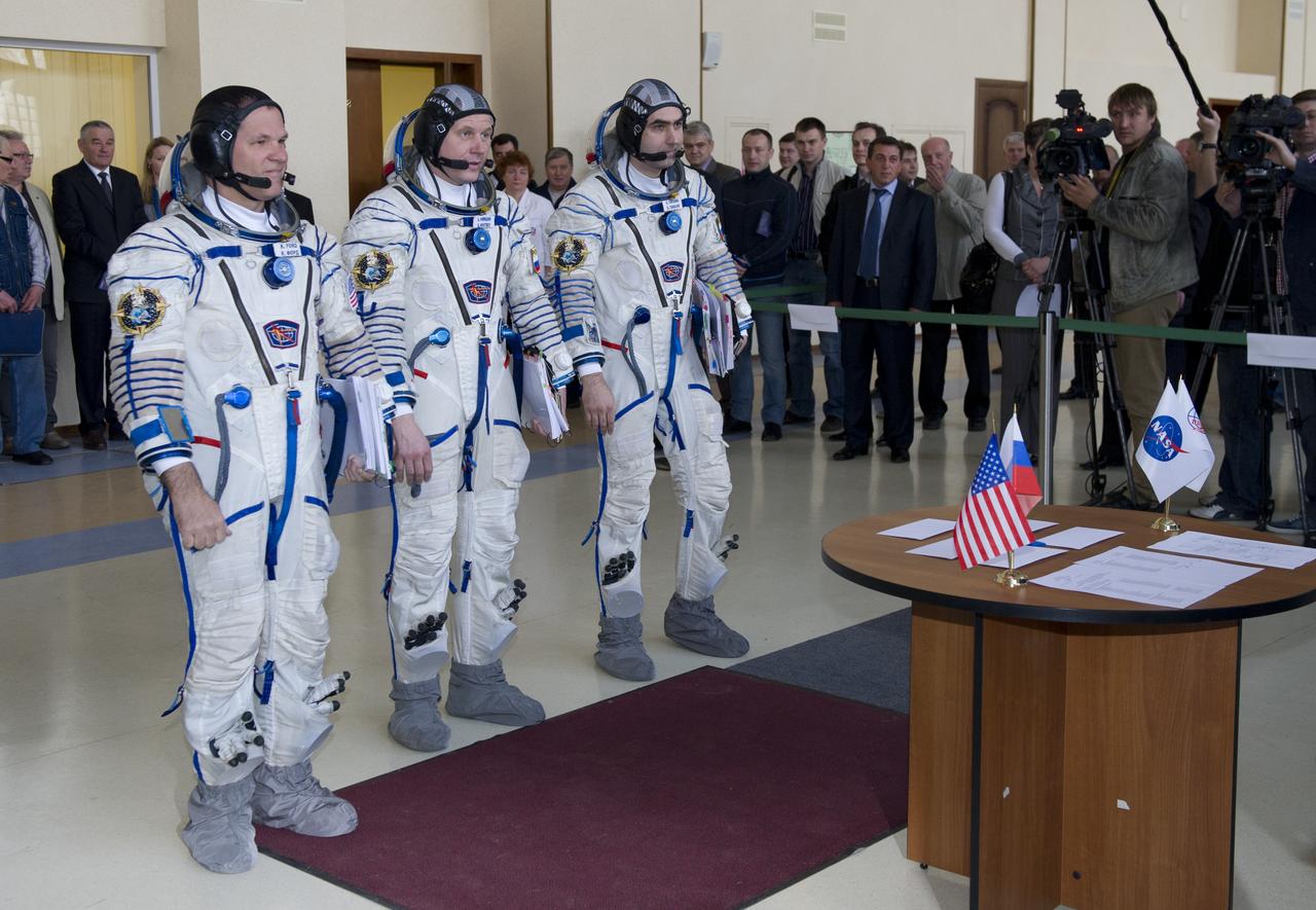 Expedition 31 backup crew members Kevin Ford, Oleg Novitskiy and Evgeny Tarelkin stand at attention before senior officials for their final qualification test in preparation for flight, Monday, April 23, 2012 at the Gagarin Cosmonaut Training Center in Star City, Russia.  Expedition 31 prime crew members commander Gennady Padalka, flight engineers Joe Acaba and Sergei Revin practiced similar scenarios nearby in advance of their final approval for launch to the International Space Station, scheduled for May 15, 2012.  Photo Credit:  (NASA/Carla Cioffi)