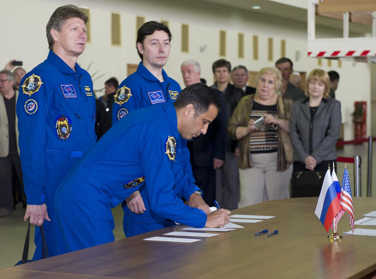 Expedition 31 NASA NASA Flight Engineer Joe Acaba signs for his International Space Station Russian segment event simulation test card before senior officials at the Gagarin Cosmonaut Training Center, Monday, April 23, 2012 in Star City, Russia, while his fellow crew members Soyuz commander Gennady Padalka (left) and Sergei Revin look on. Acaba, Padalka and Revin are set to launch May 15 from the Baikonur Cosmodrome in their Soyuz TMA-04M spacecraft to the International Space Station. Photo Credit: (NASA/Carla Cioffi)