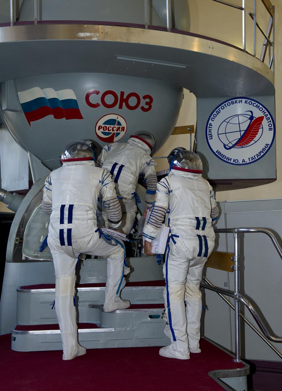 Expedition 31 NASA flight engineer Joe Acaba, right, flight engineer Sergei Revin and Soyuz Commander Gennady Padalka enter a mockup Soyuz TMA spacecraft in order to perform final qualification tests in preparation for flight, Tuesday, April 24, 2012 at the Gagarin Cosmonaut Training Center in Star City, Russia. Acaba, Revin and Padalka are set to launch to the International Space Station May 15 from the Baikonur Cosmodrome in Kazakhstan. Photo Credit: (NASA/Carla Cioffi)
