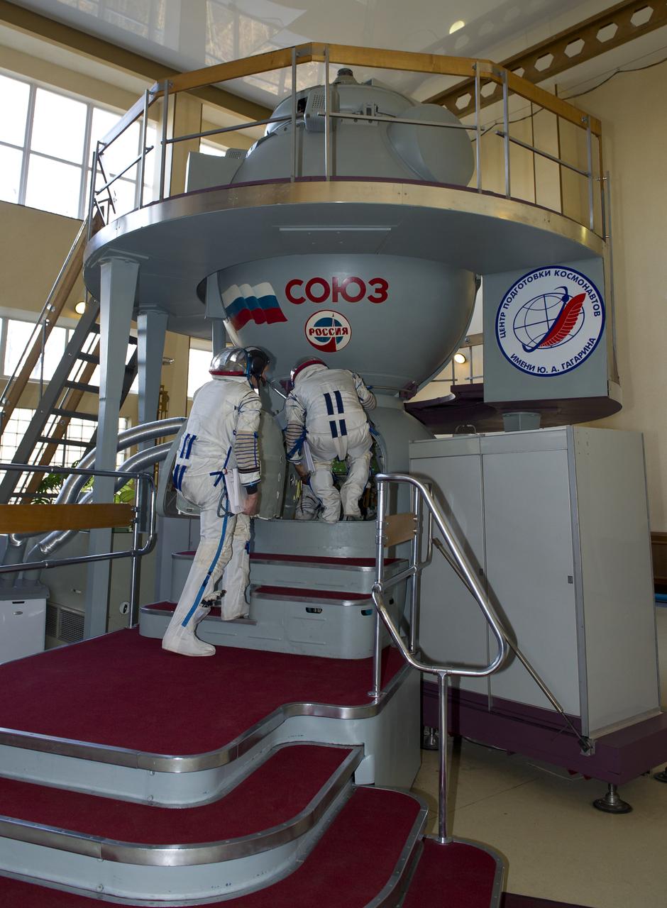 Expedition 31 NASA flight engineer Joe Acaba, entering capsule, and Soyuz Commander Gennady Padalka enter a mockup Soyuz TMA spacecraft in order to perform final qualification tests in preparation for flight, Tuesday, April 24, 2012 at the Gagarin Cosmonaut Training Center in Star City, Russia. Acaba, Padalka and flight engineer Sergei Revin are set to launch to the International Space Station May 15 from the Baikonur Cosmodrome in Kazakhstan. Photo Credit: (NASA/Carla Cioffi)