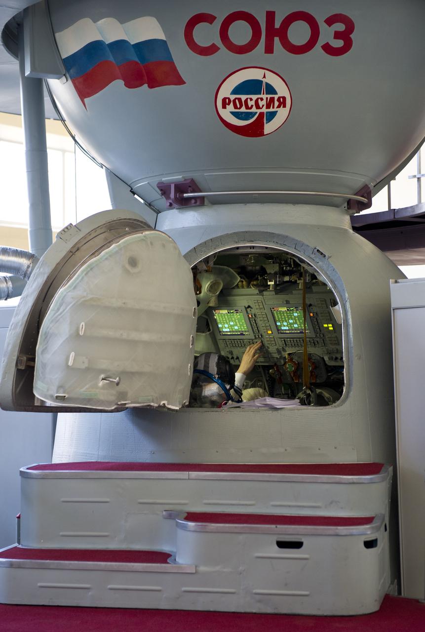 An Expedition 31 crew member's hand is seen at the controls inside the Soyuz TMA mockup Tuesday, April 24, 2012 at the Gagarin Cosmonaut Training Center in Star City, Russia.  The crew perform final qualification tests in preparation for their launch to the International Space Station May 15 from the Baikonur Cosmodrome in Kazakhstan.  Photo Credit:  (NASA/Carla Cioffi)