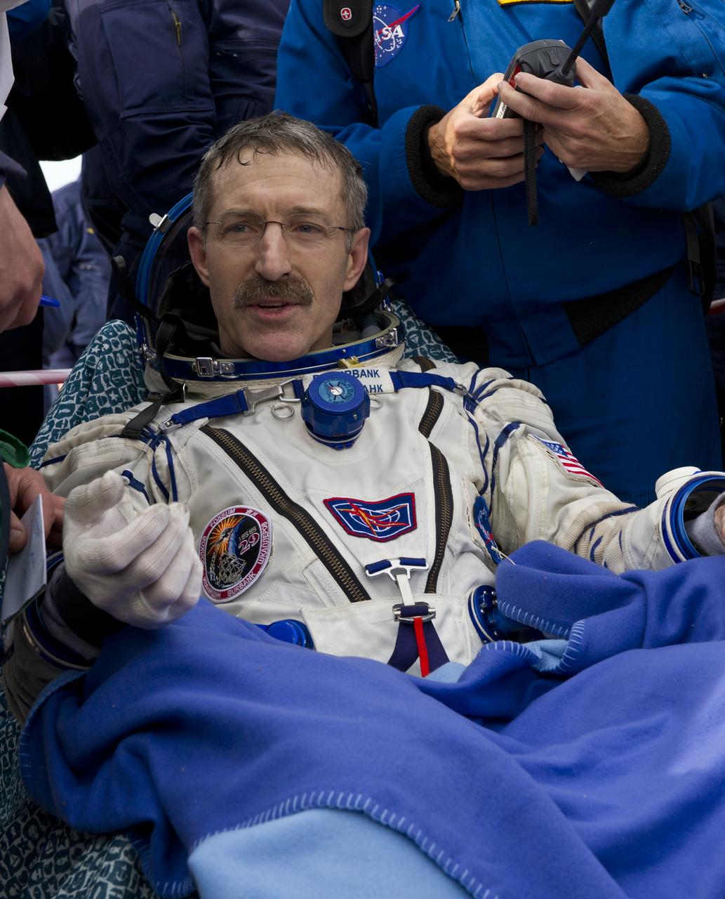 Expedition 30 Commander Dan Burbank is seen as he rests outside the Soyuz TMA-22 Capsule just minutes after he and Expedition 30 Flight Engineers Anton Shkaplerov and Anatoly Ivanishin landed in a remote area outside of the town of Arkalyk, Kazakhstan, on Friday, April 27, 2012. NASA Astronaut Burbank, Russian Cosmonauts Shkaplerov and Ivanishin are returning from more than five months onboard the International Space Station where they served as members of the Expedition 29 and 30 crews. Photo Credit: (NASA/Carla Cioffi)
