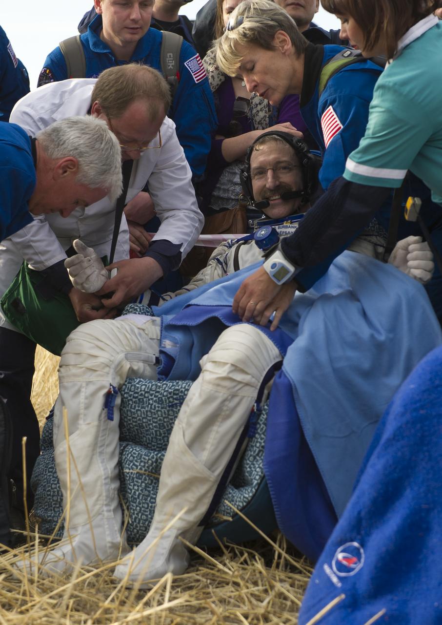 Expedition 30 Commander Dan Burbank smiles as he rests outside the Soyuz TMA-22 Capsule just minutes after he and Expedition 30 Flight Engineers Anton Shkaplerov and Anatoly Ivanishin landed in a remote area outside of the town of Arkalyk, Kazakhstan, on Friday, April 27, 2012. NASA Astronaut Burbank, Russian Cosmonauts Shkaplerov and Ivanishin are returning from more than five months onboard the International Space Station where they served as members of the Expedition 29 and 30 crews. Photo Credit: (NASA/Carla Cioffi)