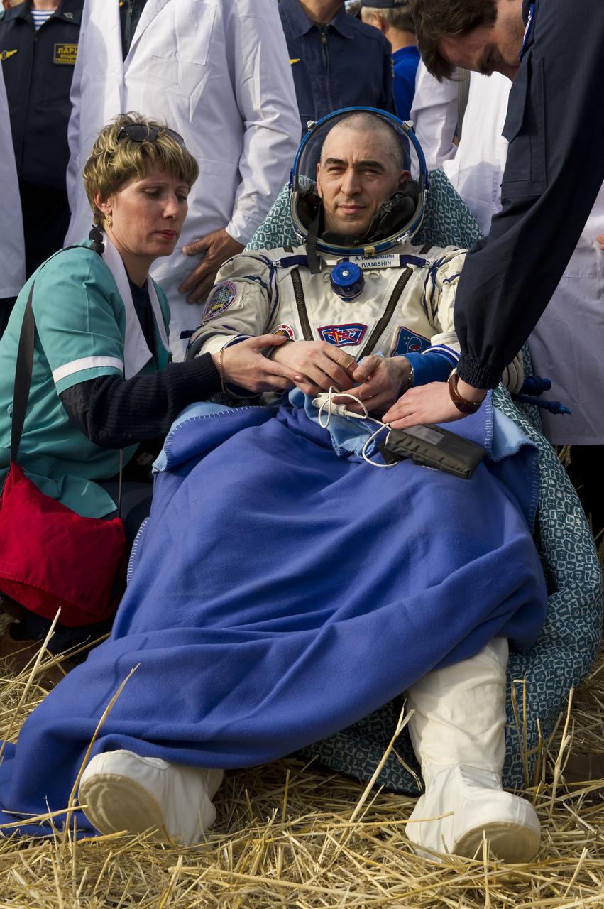 Expedition 30 flight engineer Anatoly Ivanishin rests outside the Soyuz TMA-22 Capsule just minutes after he and Expedition 30 Commander Dan Burbank and flight engineer Anton Shkaplerov landed in a remote area outside of the town of Arkalyk, Kazakhstan, on Friday, April 27, 2012. Ivanishin, Burbank, and Shkaplerov are returning from more than five months onboard the International Space Station where they served as members of the Expedition 29 and 30 crews. Photo Credit: (NASA/Carla Cioffi)