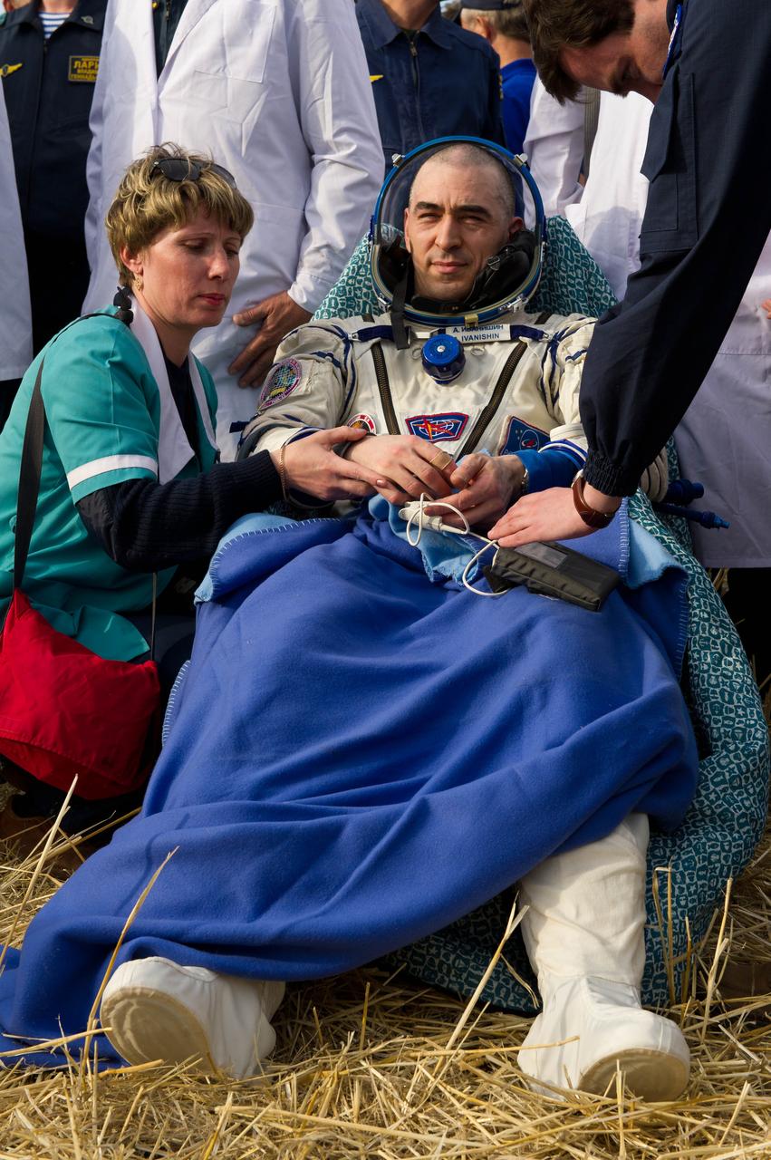 201204270011hq (April 27, 2020) --- Expedition 30 Flight Engineer Anatoly Ivanishin of Roscosmos rests outside the Soyuz TMA-22 spacecraft shortly after parachuting to Earth with crewmates (out of frame) Dan Burbank of NASA and Anton Shkaplerov of Roscosmos. Credit: NASA/Carla Cioffi