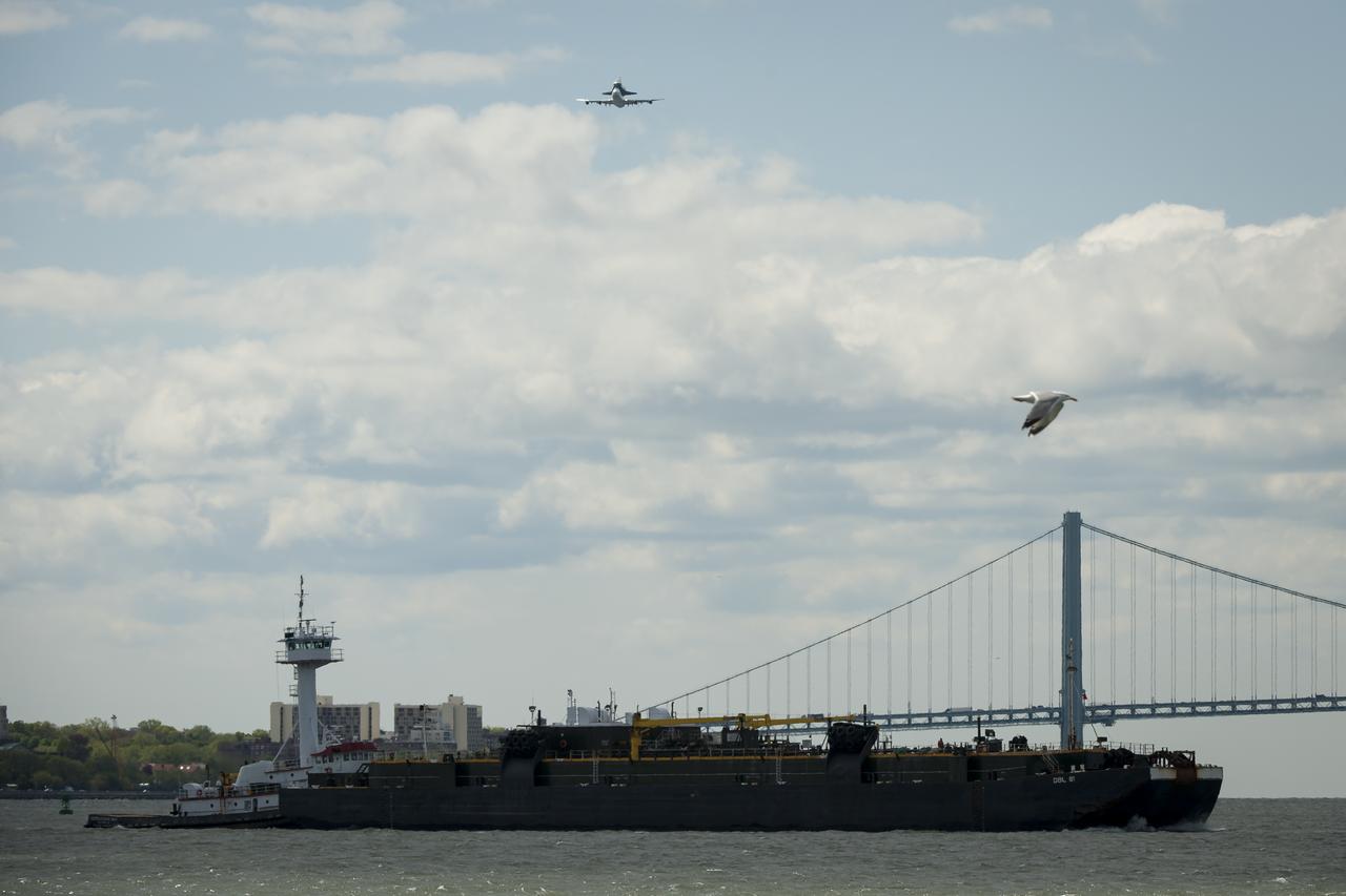 Space shuttle Enterprise, mounted atop a NASA 747 Shuttle Carrier Aircraft (SCA), is seen as it flies over the Verrazano Bridge, Friday, April 27, 2012, in New York. Enterprise was the first shuttle orbiter built for NASA performing test flights in the atmosphere and was incapable of spaceflight. Originally housed at the Smithsonian's Steven F. Udvar-Hazy Center, Enterprise will be demated from the SCA and placed on a barge that will eventually be moved by tugboat up the Hudson River to the Intrepid Sea, Air & Space Museum in June. Photo Credit: (NASA/Bill Ingalls)