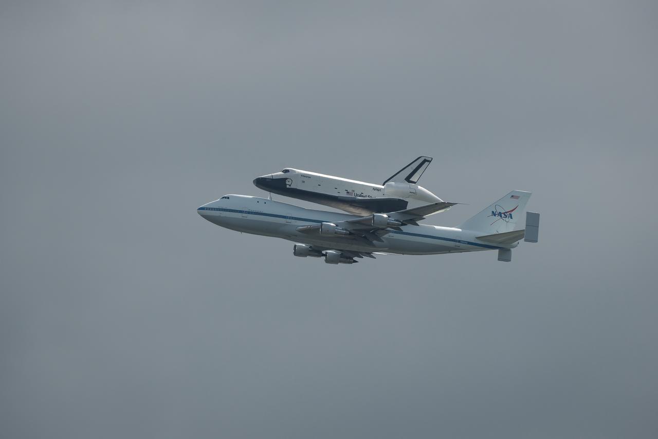 Space shuttle Enterprise, mounted atop a NASA 747 Shuttle Carrier Aircraft (SCA), is seen as it flies over the Hudson River, Friday, April 27, 2012, in New York. Enterprise was the first shuttle orbiter built for NASA performing test flights in the atmosphere and was incapable of spaceflight. Originally housed at the Smithsonian's Steven F. Udvar-Hazy Center, Enterprise will be demated from the SCA and placed on a barge that will eventually be moved by tugboat up the Hudson River to the Intrepid Sea, Air & Space Museum in June. Photo Credit: (NASA/Bill Ingalls)