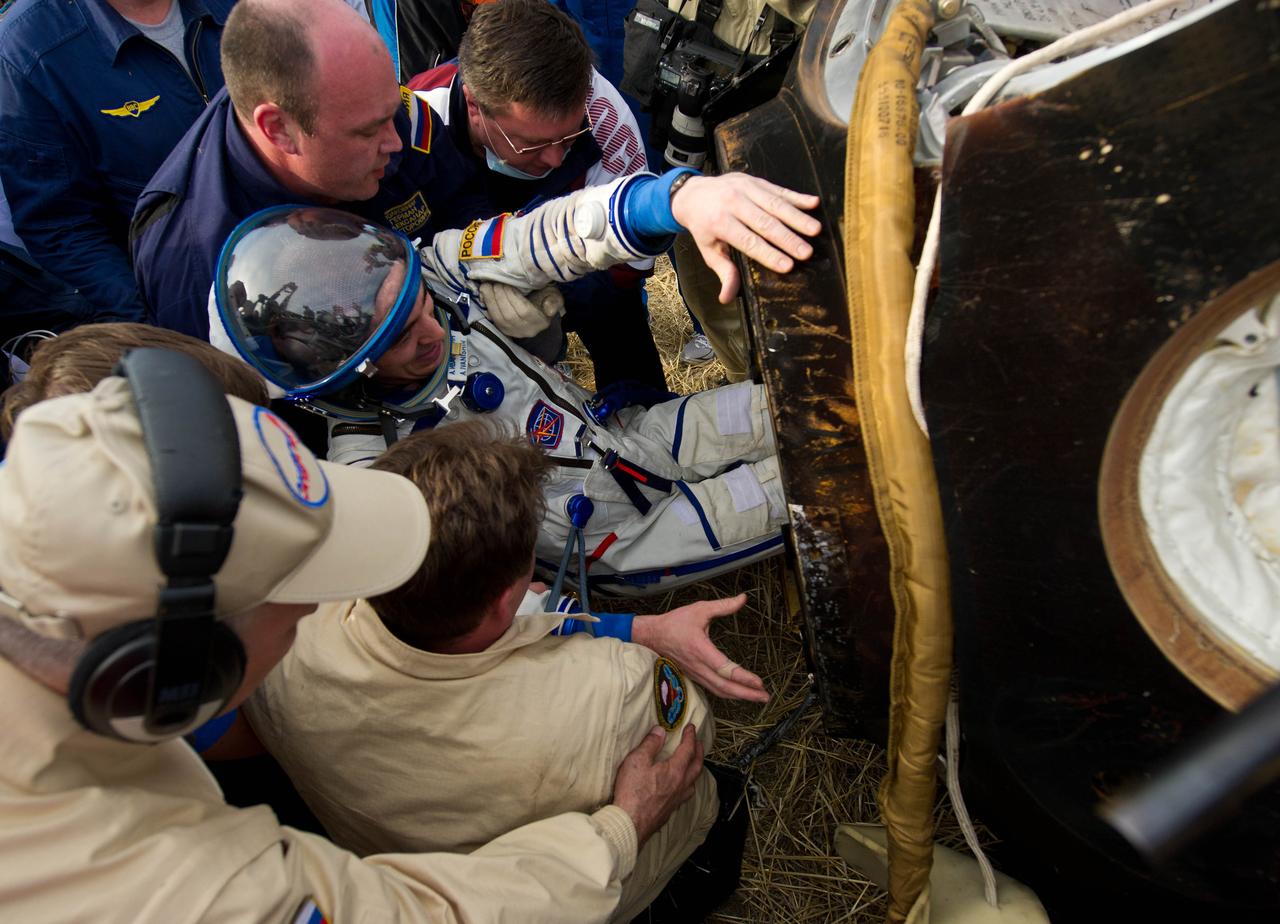201204270043hq (April 27, 2012) --- Expedition 30 Flight Engineer and Roscosmos cosmonaut Anatoly Ivanishin is extracted from the Soyuz TMA-22 spacecraft shortly after parachuting to Earth with crewmates (out of frame) Dan Burbank of NASA and Anton Shkaplerov of Roscosmos. Credit: NASA/Carla Cioffi