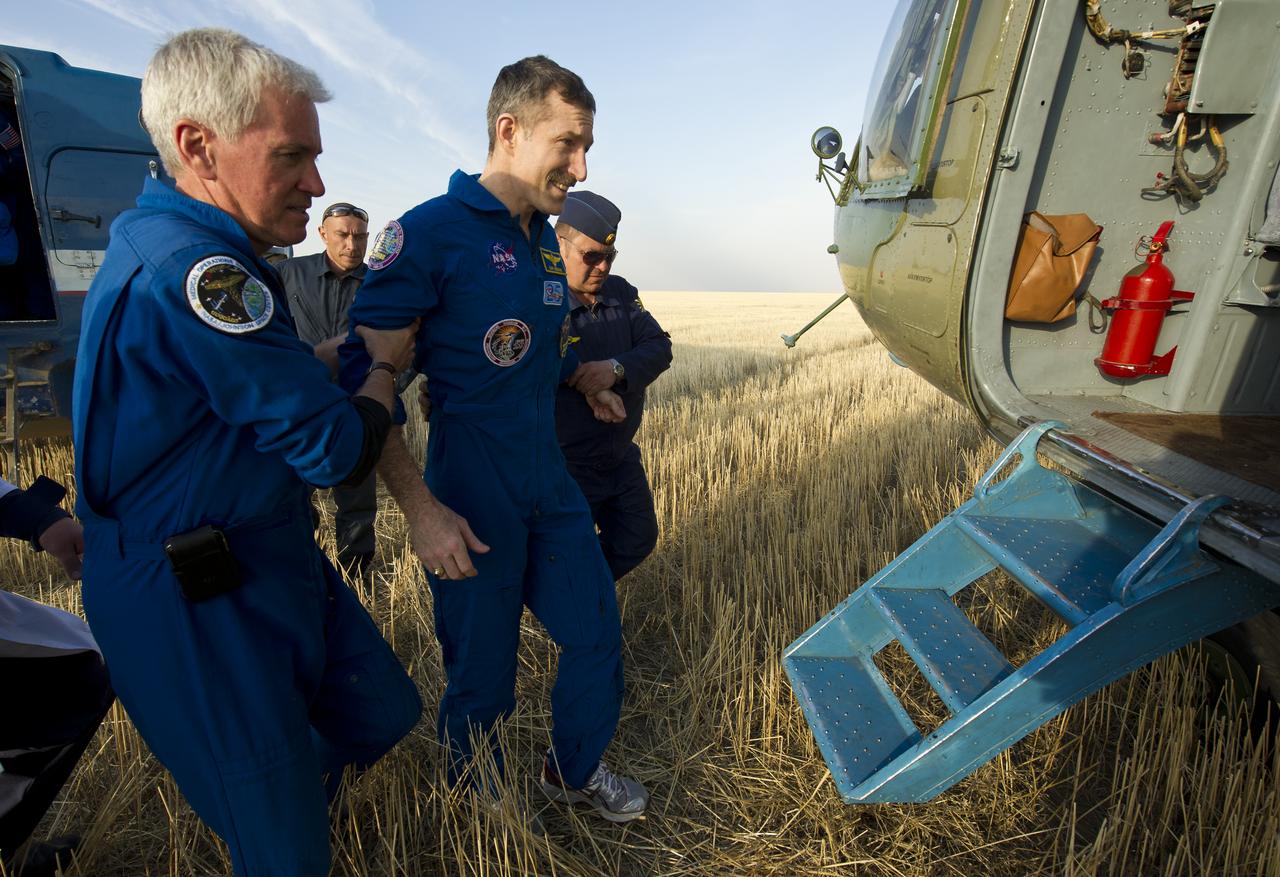 Expedition 30 Commander Dan Burbank is helped into a helicopter shortly after he and Expedition 30 Flight Engineers Anton Shkaplerov and Anatoly Ivanishin landed in a remote area outside of the town of Arkalyk, Kazakhstan, on Friday, April 27, 2012. NASA Astronaut Burbank, Russian Cosmonauts Shkaplerov and Ivanishin are returning from more than five months onboard the International Space Station where they served as members of the Expedition 29 and 30 crews. Photo Credit: (NASA/Carla Cioffi)