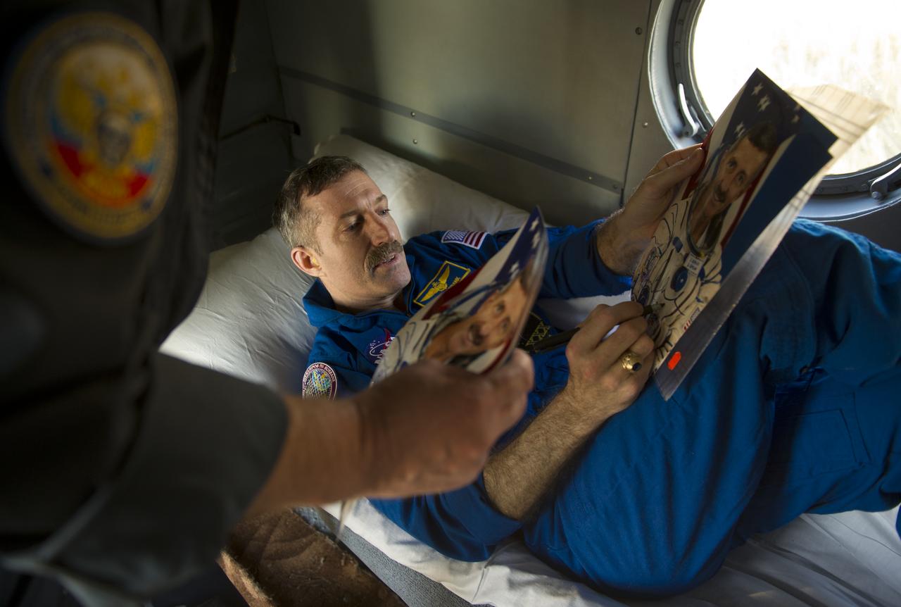Expedition 30 Commander Dan Burbank signs his autograph for Russian crew support personnel, Friday, April 27, 2012 in a remote area outside of the town of Arkalyk, Kazakhstan. Astronaut Burbank, Russian Cosmonauts Shkaplerov and Ivanishin are returning from more than five months onboard the International Space Station where they served as members of the Expedition 29 and 30 crews. Photo Credit: (NASA/Carla Cioffi)