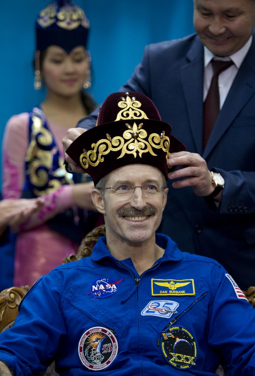 Expedition 30 Commander Daniel Burbank is seen in a gift of traditional Kazakhstan dress during a welcome ceremony at the Kostanay Airport in Kazakhstan on Friday, April 27, 2012.  NASA Astronaut Burbank, and Russian Cosmonauts Anton Shkaplerov and Anatoly Ivanishin returned from more than five months onboard the International Space Station where they served as members of the Expedition 29 and 30 crews. Photo Credit: (NASA/Carla Cioffi)