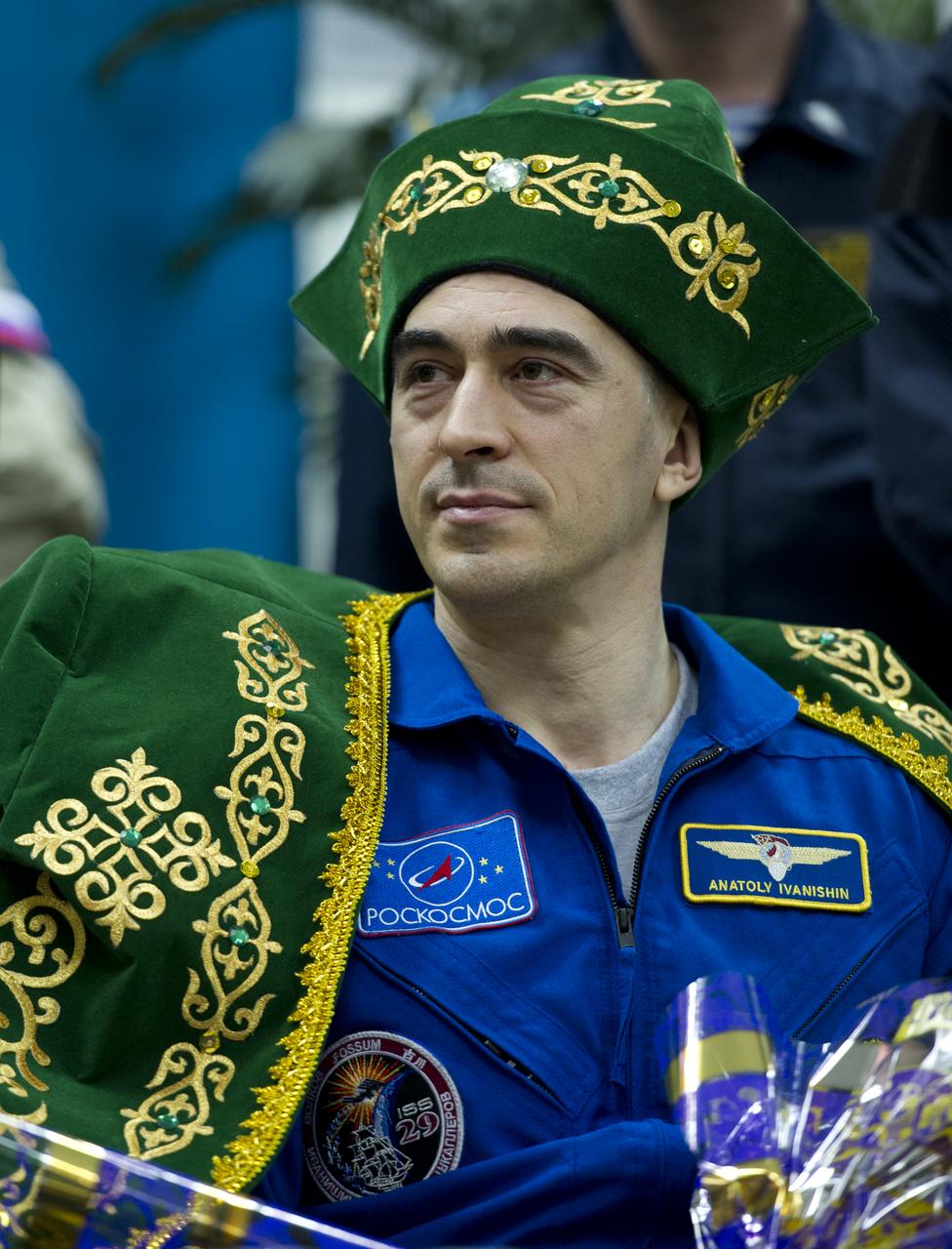 Expedition 30 Flight Engineer Anatoly Ivanishin is seen in a gift of traditional Kazakhstan dress during a welcome ceremony at the Kostanay Airport in Kazakhstan on Friday, April 27, 2012.  NASA Astronaut Burbank, and Russian Cosmonauts Anton Shkaplerov and Anatoly Ivanishin returned from more than five months onboard the International Space Station where they served as members of the Expedition 29 and 30 crews. Photo Credit: (NASA/Carla Cioffi)