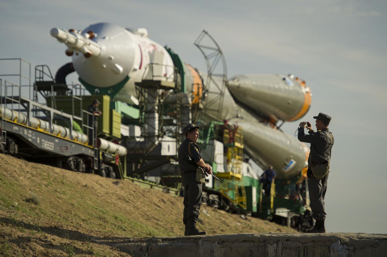 Russian security team members stop to take a photo as the Soyuz TMA-04M spacecraft is rolled out by train to launch pad one at the Baikonur Cosmodrome in Kazakhstan, Sunday, May 13, 2012. The launch of the Soyuz spacecraft with Expedition 31 Soyuz Commander Gennady Padalka and Flight Engineer Sergei Revin of Russia, and prime NASA Flight Engineer Joe Acaba is scheduled for 9:01 a.m. local time on Tuesday, May 15. Photo Credit (NASA/Bill Ingalls)