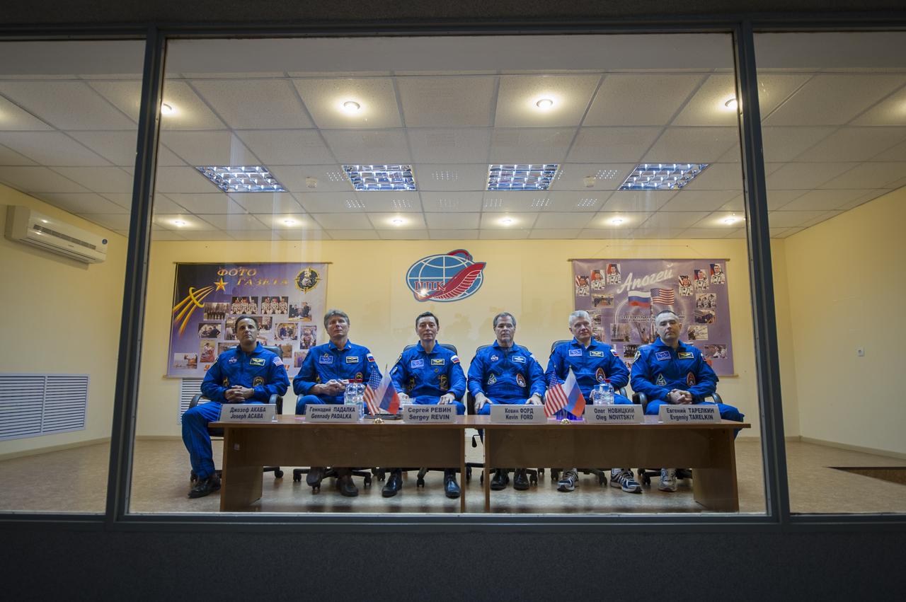 Quarantined Expedition 31 prime crew members, from left, NASA Flight Engineer Joe Acaba, Russian Soyuz Commander Gennady Padalka, Russian Flight Engineer Sergei Revin, along with Expedition 31 backup few members, Kevin Ford, Oleg Novitskiy and Evgeny Tarelkin prepare to answer reporters questions from behind glass during a prelaunch press conference held at the Cosmonaut Hotel on Monday, May 14, 2012 in Baikonur, Kazakhstan.  The launch of the Soyuz spacecraft with Padalka, Flight Engineer Sergei Revin of Russia, and prime NASA Flight Engineer Joe Acaba is scheduled for 9:01 a.m. local time on Tuesday, May 15.  Photo Credit (NASA/Bill Ingalls)