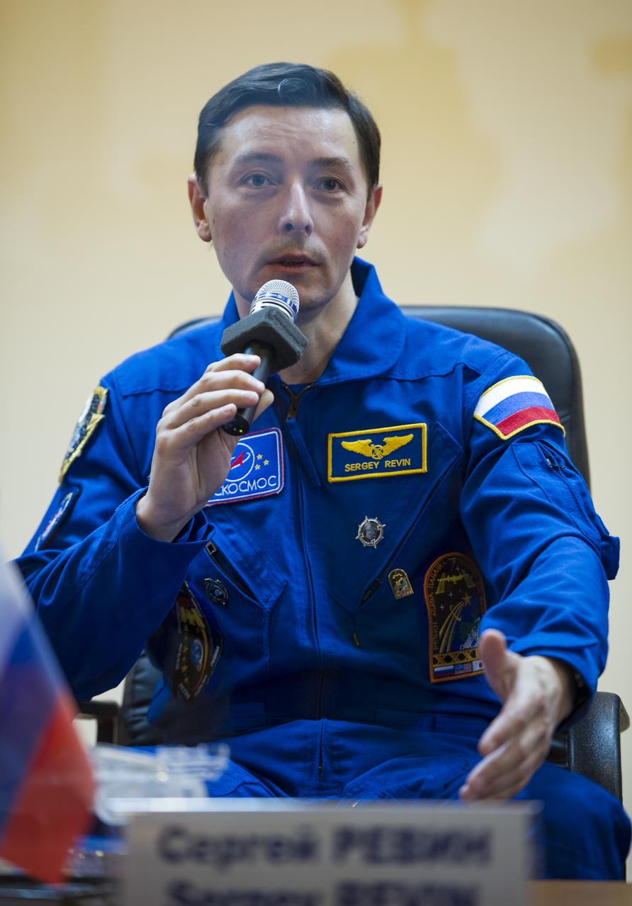 Quarantined Expedition 31 Flight Engineer Sergei Revin of Russia answers reporters questions from behind glass during a prelaunch press conference held at the Cosmonaut Hotel on Monday, May 14, 2012 in Baikonur, Kazakhstan.  The launch of the Soyuz spacecraft with Revin, Soyuz Commander Gennady Padalka, and NASA Flight Engineer Joe Acaba is scheduled for 9:01 a.m. local time on Tuesday, May 15.  Photo Credit (NASA/Bill Ingalls)