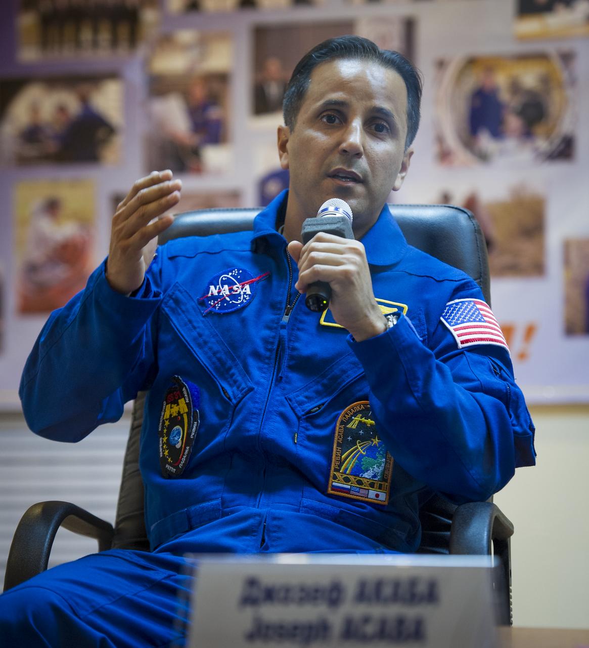 Quarantined Expedition 31 Flight Engineer Joe Acaba answers reporters questions from behind glass during a prelaunch press conference held at the Cosmonaut Hotel on Monday, May 14, 2012 in Baikonur, Kazakhstan.  The launch of the Soyuz spacecraft with Acaba, Soyuz Commander Gennady Padalka, and Flight Engineer Sergei Revin is scheduled for 9:01 a.m. local time on Tuesday, May 15.  Photo Credit (NASA/Bill Ingalls)