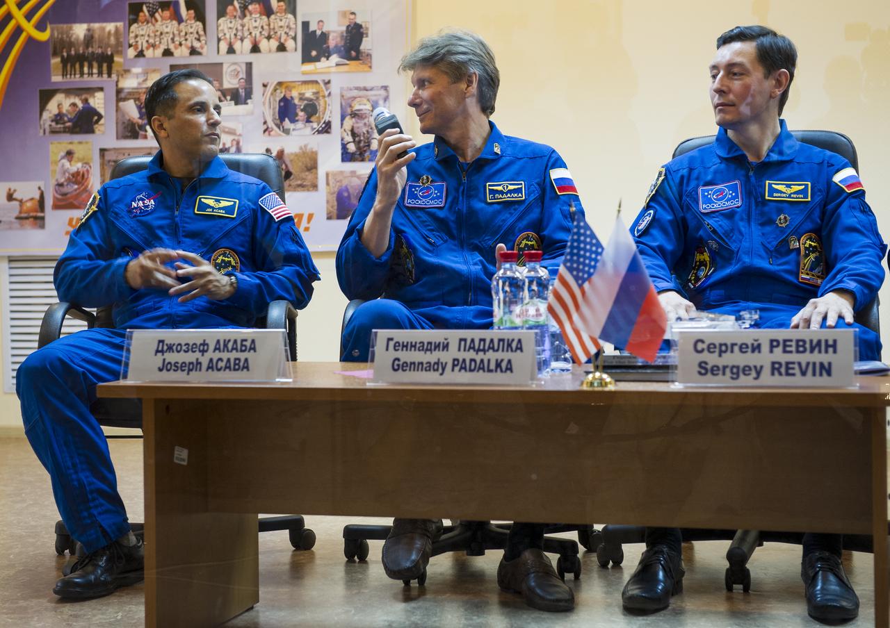 Quarantined Expedition 31 prime crew members, from left, NASA Flight Engineer Joe Acaba, Russian Soyuz Commander Gennady Padalka, and Russian Flight Engineer Sergei Revin answer reporters questions from behind glass during a prelaunch press conference held at the Cosmonaut Hotel on Monday, May 14, 2012 in Baikonur, Kazakhstan.  The launch of the Soyuz spacecraft with the crew of three is scheduled for 9:01 a.m. local time on Tuesday, May 15.  Photo Credit (NASA/Bill Ingalls)