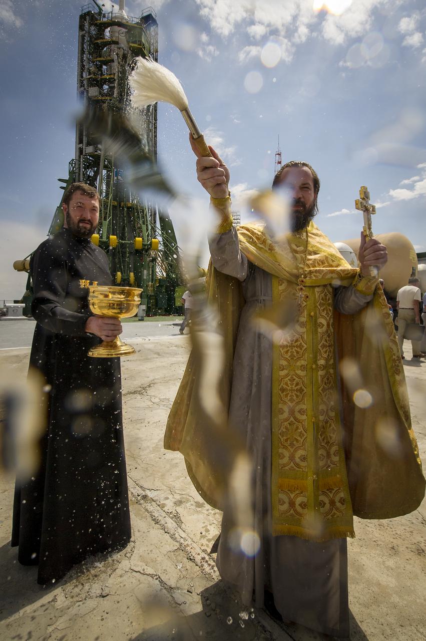 An Orthodox priest blesses members of the media shortly after blessing the Soyuz rocket at the Baikonur Cosmodrome Launch pad on Monday, May 14, 2012 in Kazakhstan. The launch of the Soyuz spacecraft with Expedition 31 Soyuz Commander Gennady Padalka and Flight Engineer Sergei Revin of Russia, and prime NASA Flight Engineer Joe Acaba is scheduled for 9:01 a.m. local time on Tuesday, May 15.  Photo Credit (NASA/Bill Ingalls)
