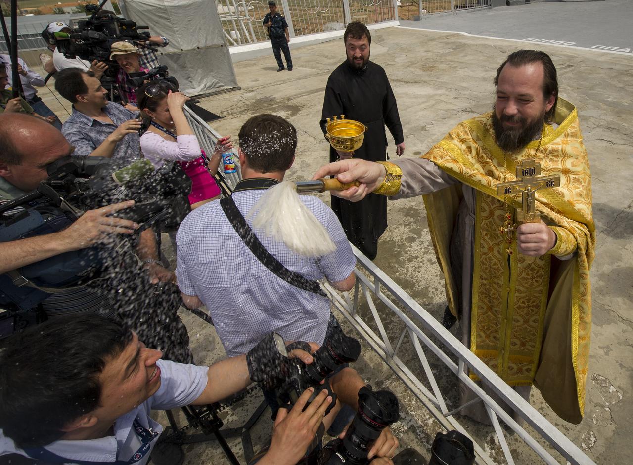 An Orthodox priest blesses members of the media shortly after blessing the Soyuz rocket at the Baikonur Cosmodrome Launch pad on Monday, May 14, 2012 in Kazakhstan. The launch of the Soyuz spacecraft with Expedition 31 Soyuz Commander Gennady Padalka and Flight Engineer Sergei Revin of Russia, and prime NASA Flight Engineer Joe Acaba is scheduled for 9:01 a.m. local time on Tuesday, May 15.  Photo Credit (NASA/Bill Ingalls)