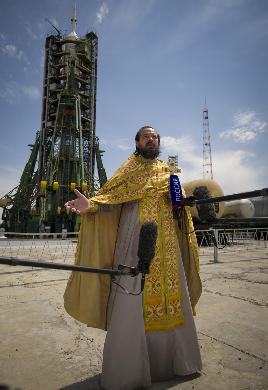 An Orthodox priest talks to members of the press just after having blessed the Soyuz rocket at the Baikonur Cosmodrome Launch pad on Monday, May 14, 2012 in Kazakhstan.  The launch of the Soyuz spacecraft with Expedition 31 Soyuz Commander Gennady Padalka and Flight Engineer Sergei Revin of Russia, and prime NASA Flight Engineer Joe Acaba is scheduled for 9:01 a.m. local time on Tuesday, May 15.  Photo Credit (NASA/Bill Ingalls)
