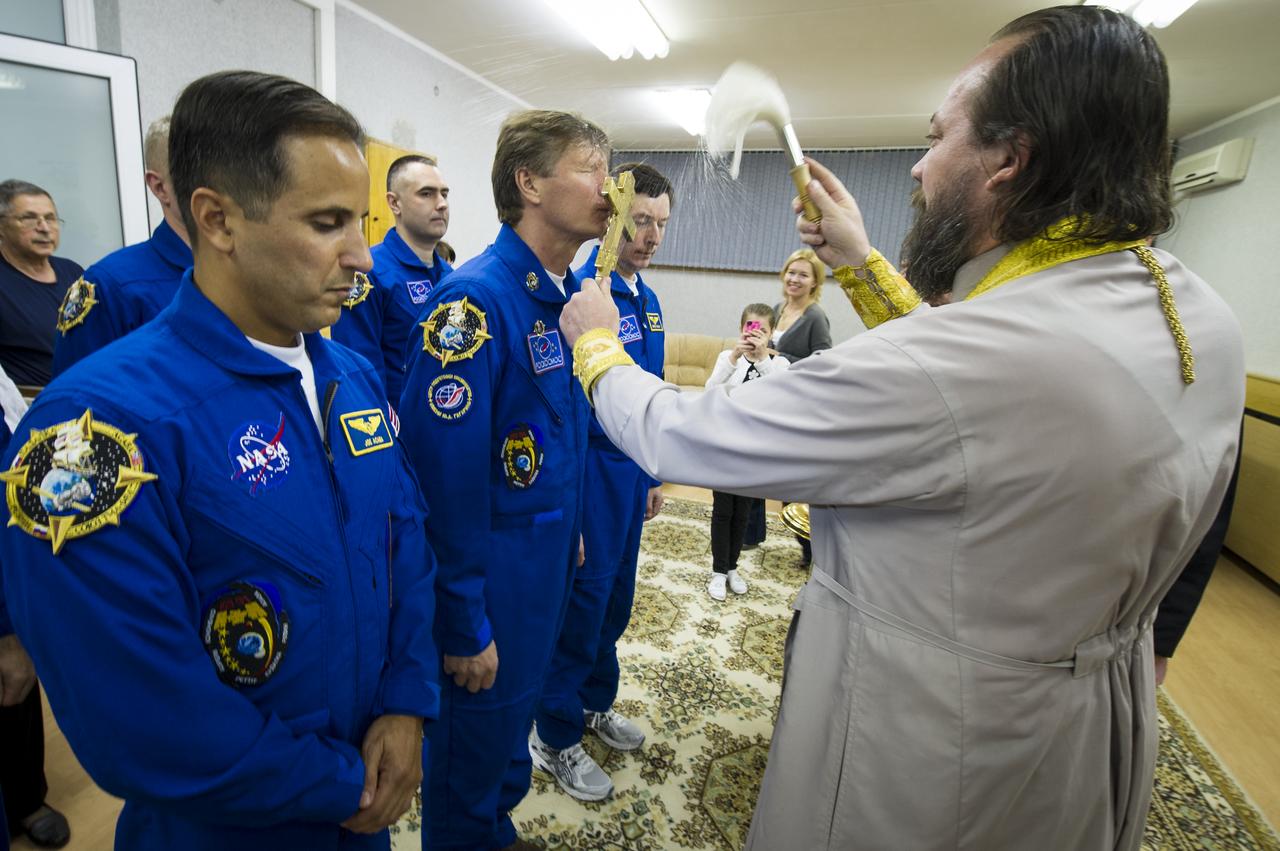Expedition 31 crew members Joe Acaba, left, Commander Gennady Padalka and Sergei Revin, right, receive the traditional blessing by an Orthodox priest at the Cosmonaut Hotel on Tuesday, May 15, 2012 in Baikonur, Kazakhstan. The Soyuz spacecraft with Expedition 31 Soyuz Commander Gennady Padalka, Flight Engineer Sergei Revin, and NASA Flight Engineer Joe Acaba aboard launched at 9:01 a.m. Kazakhstan time on Tuesday, May 15. Photo Credit (NASA/Bill Ingalls)