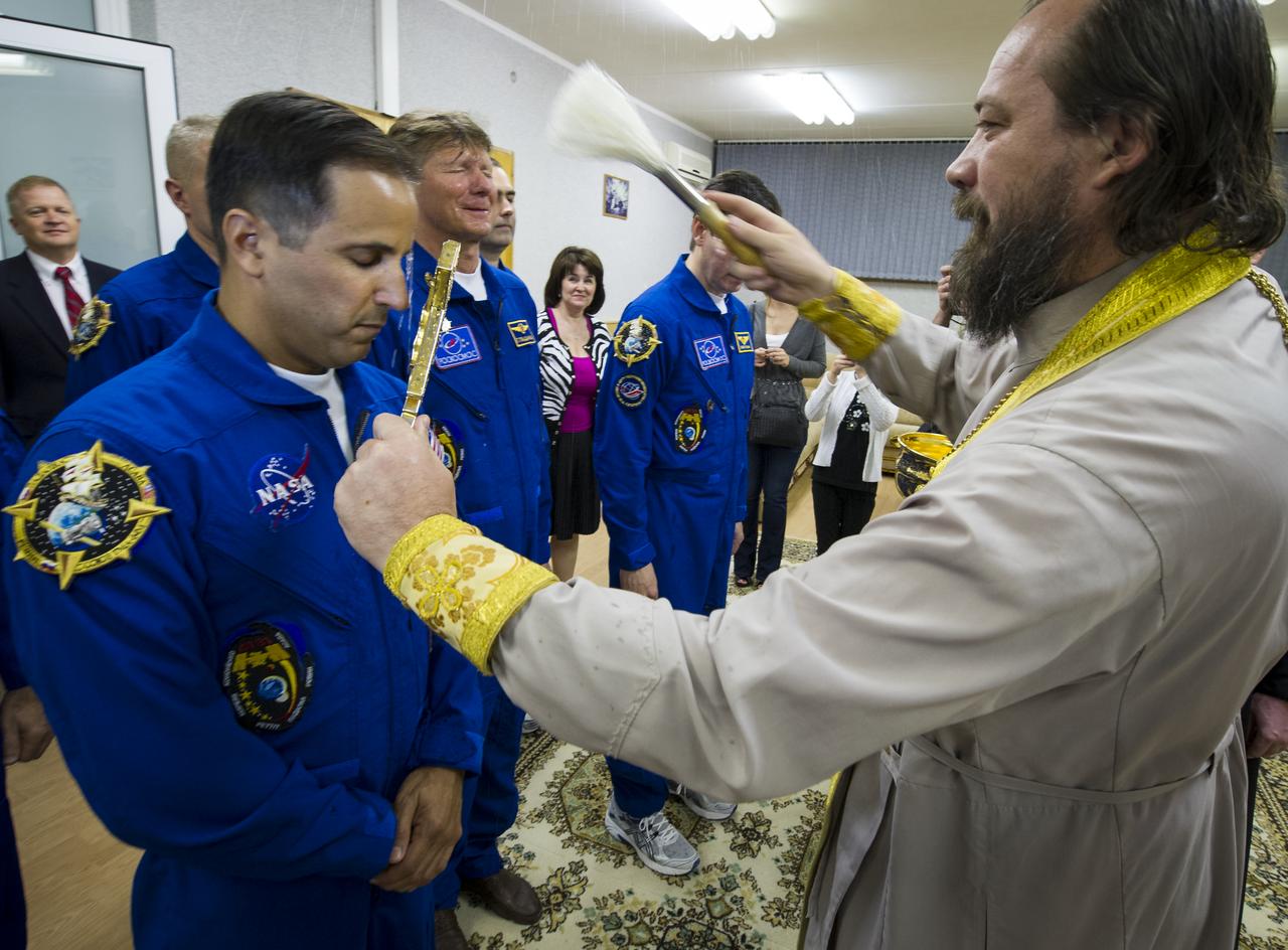 Expedition 31 crew members Joe Acaba, left, Commander Gennady Padalka and Sergei Revin, right, receive the traditional blessing by an Orthodox priest at the Cosmonaut Hotel on Tuesday, May 15, 2012 in Baikonur, Kazakhstan. The Soyuz spacecraft with Expedition 31 Soyuz Commander Gennady Padalka, Flight Engineer Sergei Revin, and NASA Flight Engineer Joe Acaba aboard launched at 9:01 a.m. Kazakhstan time on Tuesday, May 15. Photo Credit (NASA/Bill Ingalls)