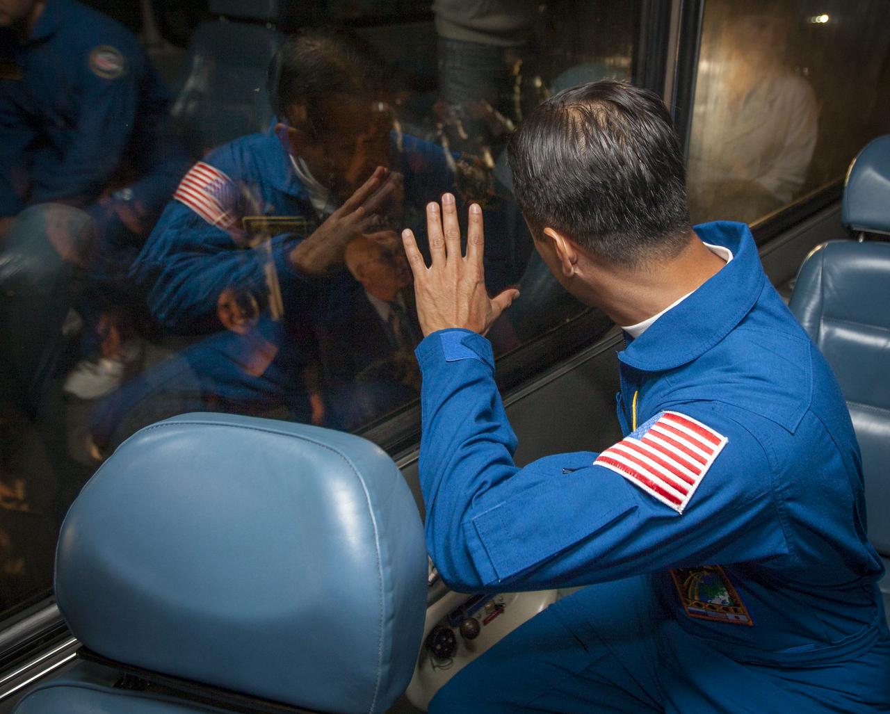 Expedition 31 Flight Engineer Joe Acaba waves farewell to friends and family as his bus departs the Cosmonaut Hotel with fellow Expedition 31 crew members, Commander Gennady Padalka and Sergei Revin on Tuesday, May 15, 2012 in Baikonur, Kazakhstan. The Soyuz spacecraft with Expedition 31 Soyuz Commander Gennady Padalka, Flight Engineer Sergei Revin, and Acaba onboard launched at 9:01 a.m. Kazakhstan time on Tuesday, May 15.  Photo Credit: (NASA/GCTC/Andrey Shelepin)