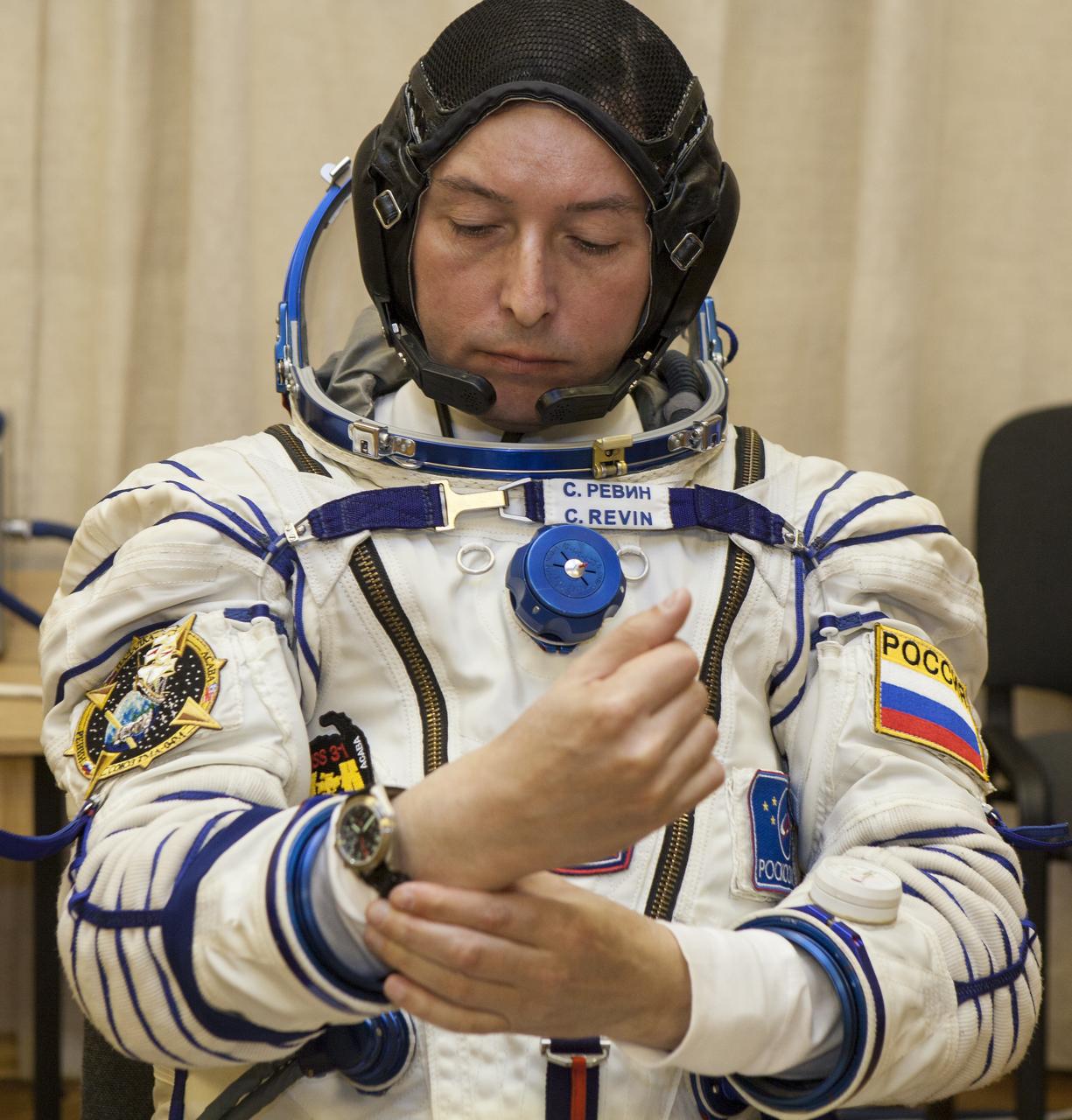 Expedition 31 Flight Engineer Sergei Revin of Russia adjust his watch shirtly after donning his Russian Sokol suit in preparation for his launch onboard the Soyuz TMA-04M on Tuesday, May 15, 2012 at the Baikonur Cosmodrome in Kazakhstan. The Soyuz spacecraft with Revin, Expedition 31 Soyuz Commander Gennady Padalka, and Flight Engineer Joe Acaba onboard, launched at 9:01 a.m. Kazakhstan time on Tuesday, May 15.  Photo Credit: (NASA/GCTC/Andrey Shelepin)