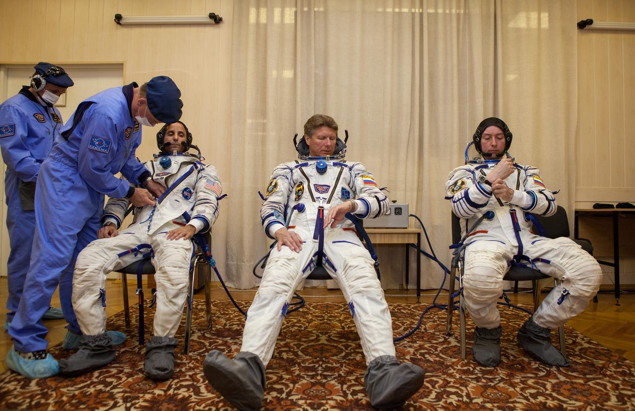 Expedition 31 Flight Engineer Joe Acaba, left, Soyuz Commander Gennady Padalka, and Flight Engineer Sergei Revin, right, don their Russian Sokol suits ahead of their launch onboard the Soyuz TMA-04M on Tuesday, May 15, 2012 at the Baikonur Cosmodrome in Kazakhstan. The Soyuz spacecraft with Padalka, Revin, and Acaba onboard, launched at 9:01 a.m. Kazakhstan time on Tuesday, May 15. Photo Credit: (NASA/GCTC/Andrey Shelepin)