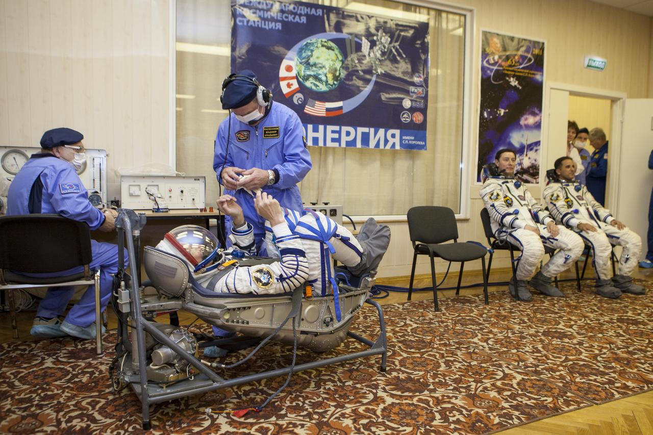 Expedition 31 Soyuz Commander Gennady Padalka lies in a chair to have his Russian Sokol suit pressure checked in preparation for his launch onboard the Soyuz TMA-04M on Tuesday, May 15, 2012 at the Baikonur Cosmodrome in Kazakhstan. The Soyuz spacecraft with Padalka, Flight Engineer Sergei Revin and Flight Engineer Joe Acaba onboard, launched at 9:01 a.m. Kazakhstan time on Tuesday, May 15. Photo Credit: (NASA/GCTC/Andrey Shelepin)