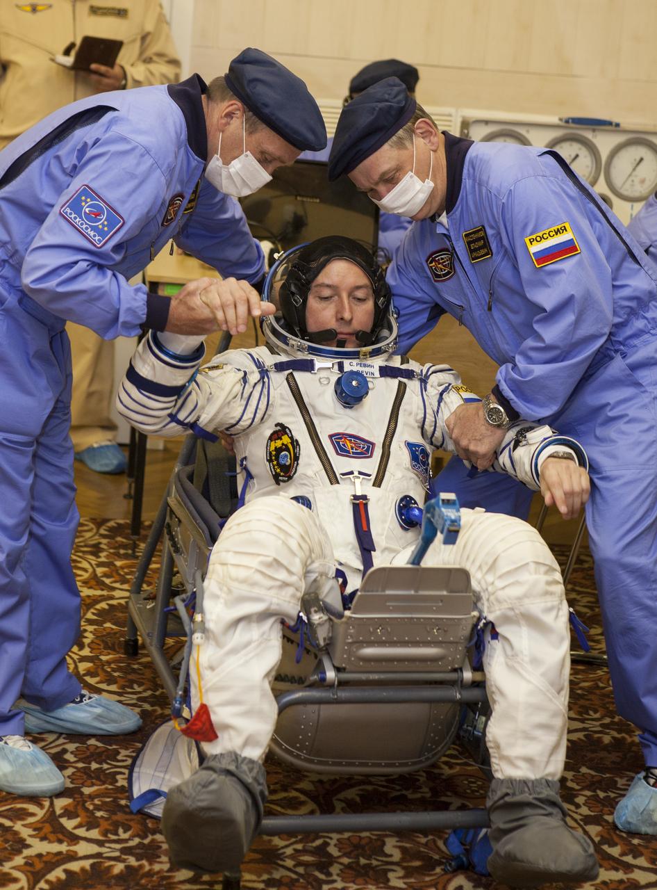 Flight Engineer Sergei Revin sits down to have his Russian Sokol suit pressure checked in preparation for his launch onboard the Soyuz TMA-04M on Tuesday, May 15, 2012 at the Baikonur Cosmodrome in Kazakhstan. The Soyuz spacecraft with Revin, Expedition 31 Soyuz Commander Gennady Padalka and Flight Engineer Joe Acaba onboard, launched at 9:01 a.m. Kazakhstan time on Tuesday, May 15.  Photo Credit: (NASA/GCTC/Andrey Shelepin)