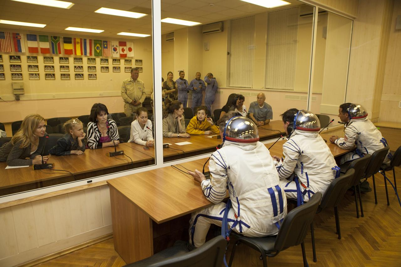 Expedition 31 Soyuz Commander Gennady Padalka, left, Flight Engineer Sergei Revin, and Flight Engineer Joe Acaba, right, talk with family members after having their Russian Sokol suits pressure checked in preparation for their launch onboard the Soyuz TMA-04M on Tuesday, May 15, 2012 at the Baikonur Cosmodrome in Kazakhstan. The Soyuz spacecraft with Padalka, Revin, and Acaba onboard, launched at 9:01 a.m. Kazakhstan time on Tuesday, May 15. Photo Credit: (NASA/GCTC/Andrey Shelepin)